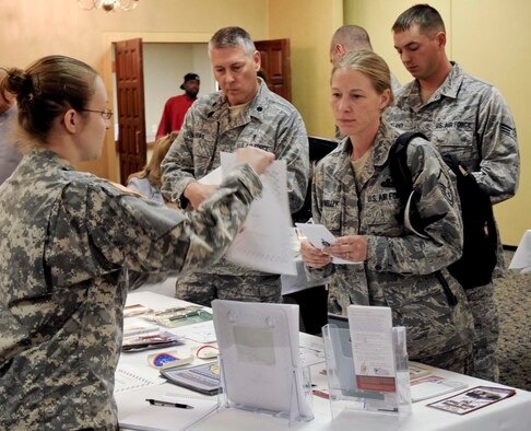 U.S. Army Sgt. Mary Hicks, veterinarian technician, explains different services the veterinary clinic provides to Airmen during the Happy Landings event at the Dakota’s Club at Ellsworth Air Force Base, S.D., Oct. 16, 2012. The veterinarian clinic, along with several other base facilities and local businesses, set up booths to provide Airmen and their families with information on the wide range of services and opportunities available on base and in the local area. (U.S. Air Force photo by Airman 1st Class Anania Tekurio/Released)