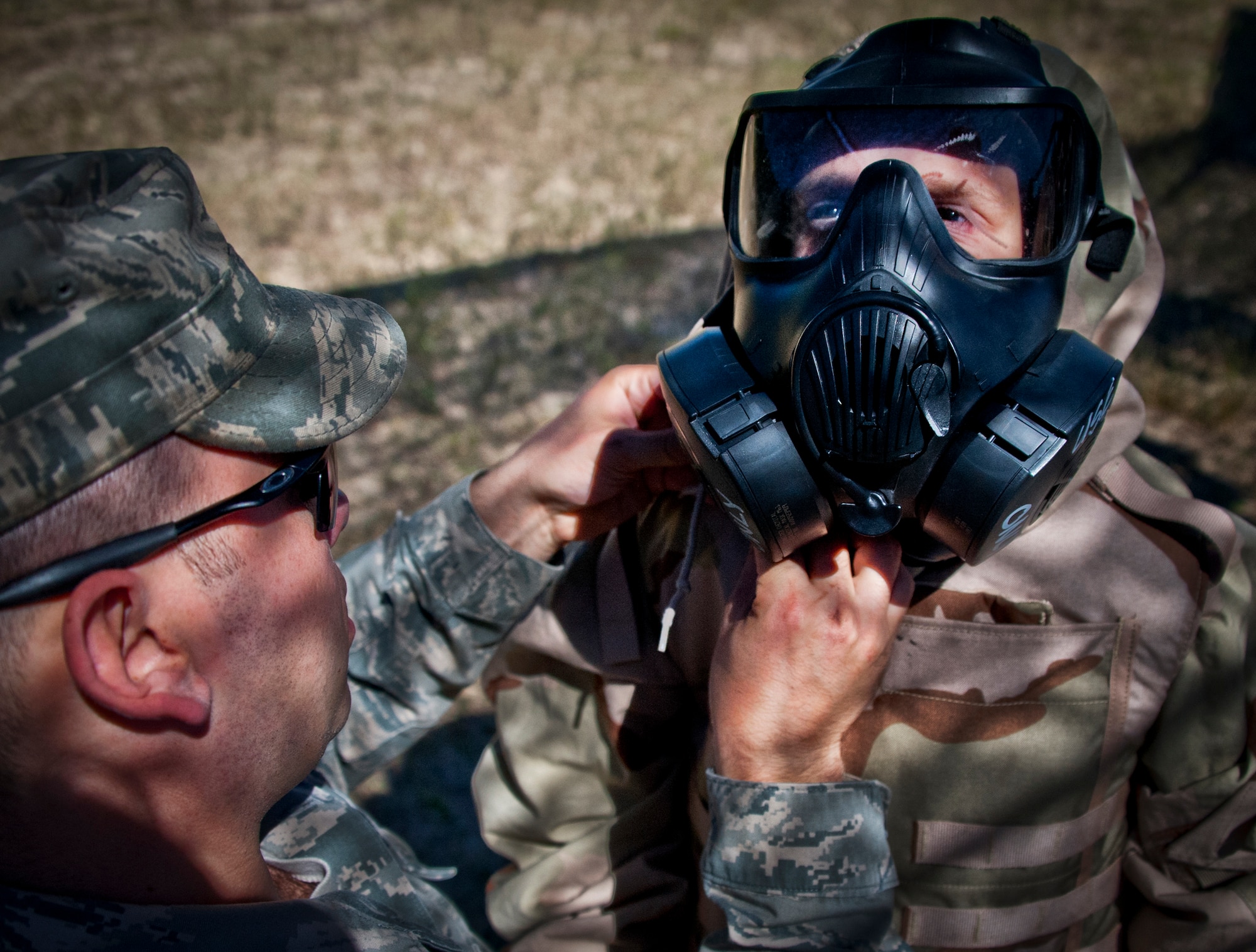 Potential, future Airman, Cameron Nelson, escorted by Sgt Michael Bellino, Marine Fighter Attack Squadron 501, tries on a gas mask after the 96th Ground Combat Training Squadron demonstration during Operation Hero at Eglin Air Force Base, Fla., Oct. 20. The event, sponsored by the 96th Test Wing Airman and Family Readiness Center, teaches children the experiences their military family members go through during predeployment and while out in the field. (U.S. Air Force photo/Randy Gon)
