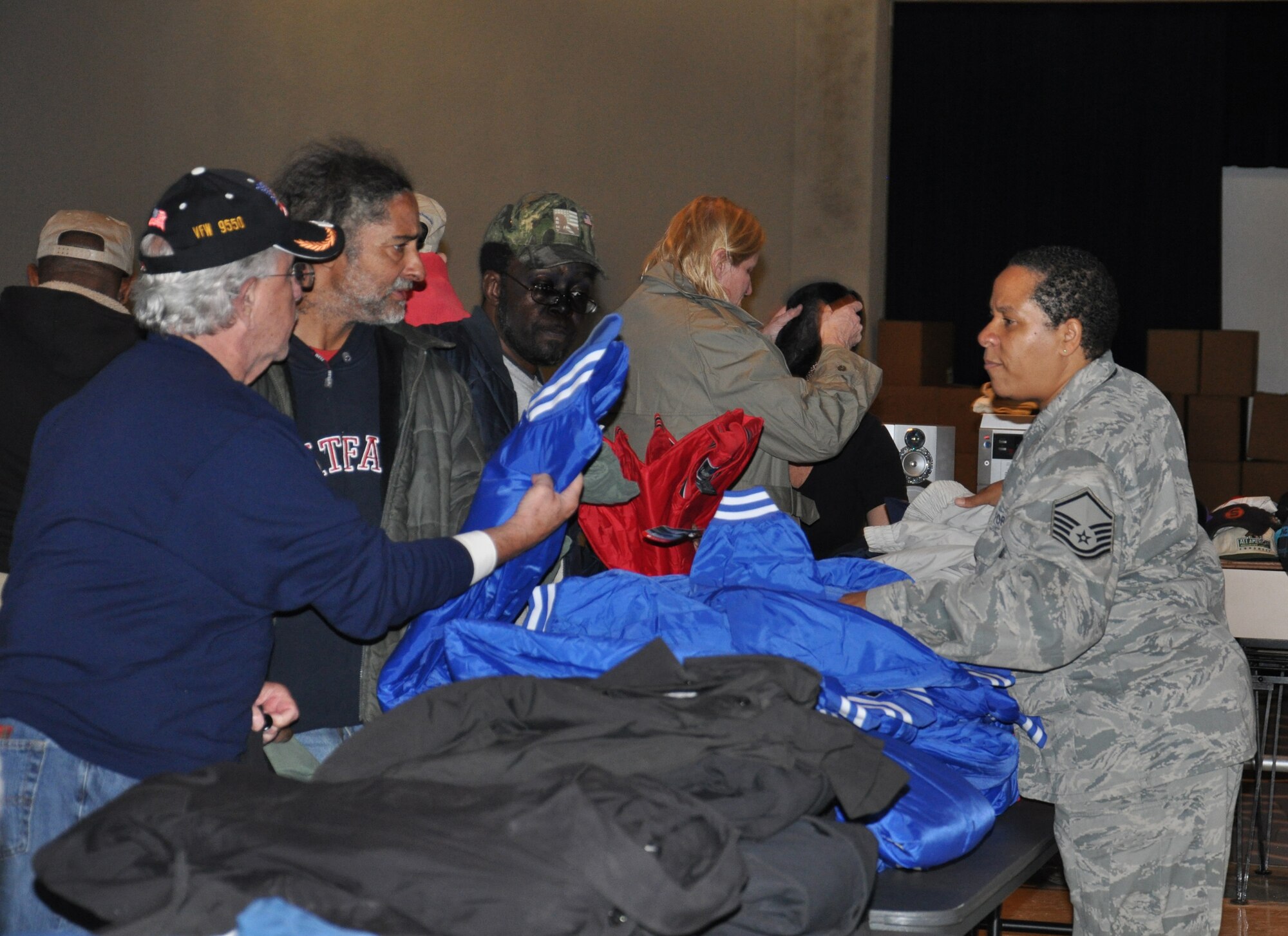 WRIGHT-PATTERSON AIR FORCE BASE, Ohio - Master Sgt. Cynthia Jones, 445th Aircraft Maintenance Squadron information management craftsman, hands out jackets to those in need during the 2012 Dayton Veteran’s Affairs Homeless Stand Down Oct. 19 at the Dayton VA Medical Center. More than 20 volunteers from the wing along with the VA staff helped the more than 300 homeless veterans by handing out donated clothing items and visiting with the men and women that came through the line. (U.S. Air Force photo/Lt. Col. Cynthia Harris)
