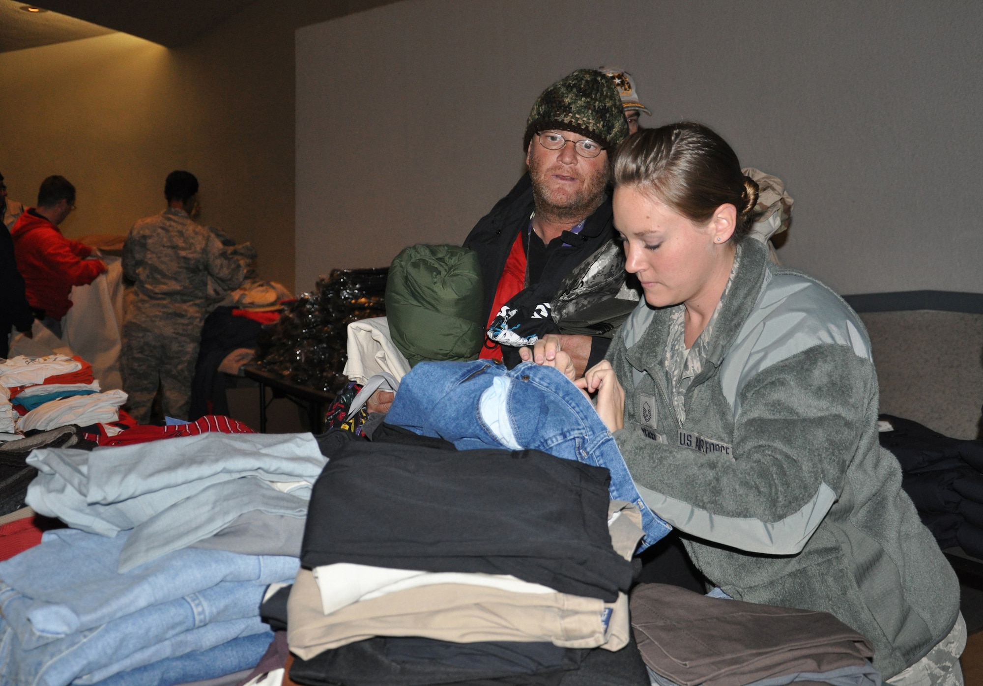 WRIGHT-PATTERSON AIR FORCE BASE, Ohio - Master Sgt. Kerrie Yeager, 445th Logistics Readiness Squadron traffic management flight chief, helps a veteran find the right size of pants that will fit him during the 2012 Dayton Veteran’s Affairs Homeless Stand Down Oct. 19 held at the Dayton VA Medical Center. More than 20 volunteers from the wing along with the VA staff helped more than 300 homeless veterans by handing out donated clothing items and visiting with the men and women that came through the line. (U.S. Air Force photo/Lt. Col. Cynthia Harris)