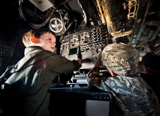 Corbin Follmar watches his brother, Graedin, operate a station on board a static C-130 aircraft during Operation Hero at Eglin Air Force Base, Fla., Oct. 20. The boys' mother, Master Sgt. Erika Follmar, is assigned to the 96th Test Wing's staff agency. The event, sponsored by the 96th Test Wing Airman and Family Readiness Center, teaches children the experiences their military family members go through during predeployment and while out in the field. (U.S. Air Force photo/Randy Gon)