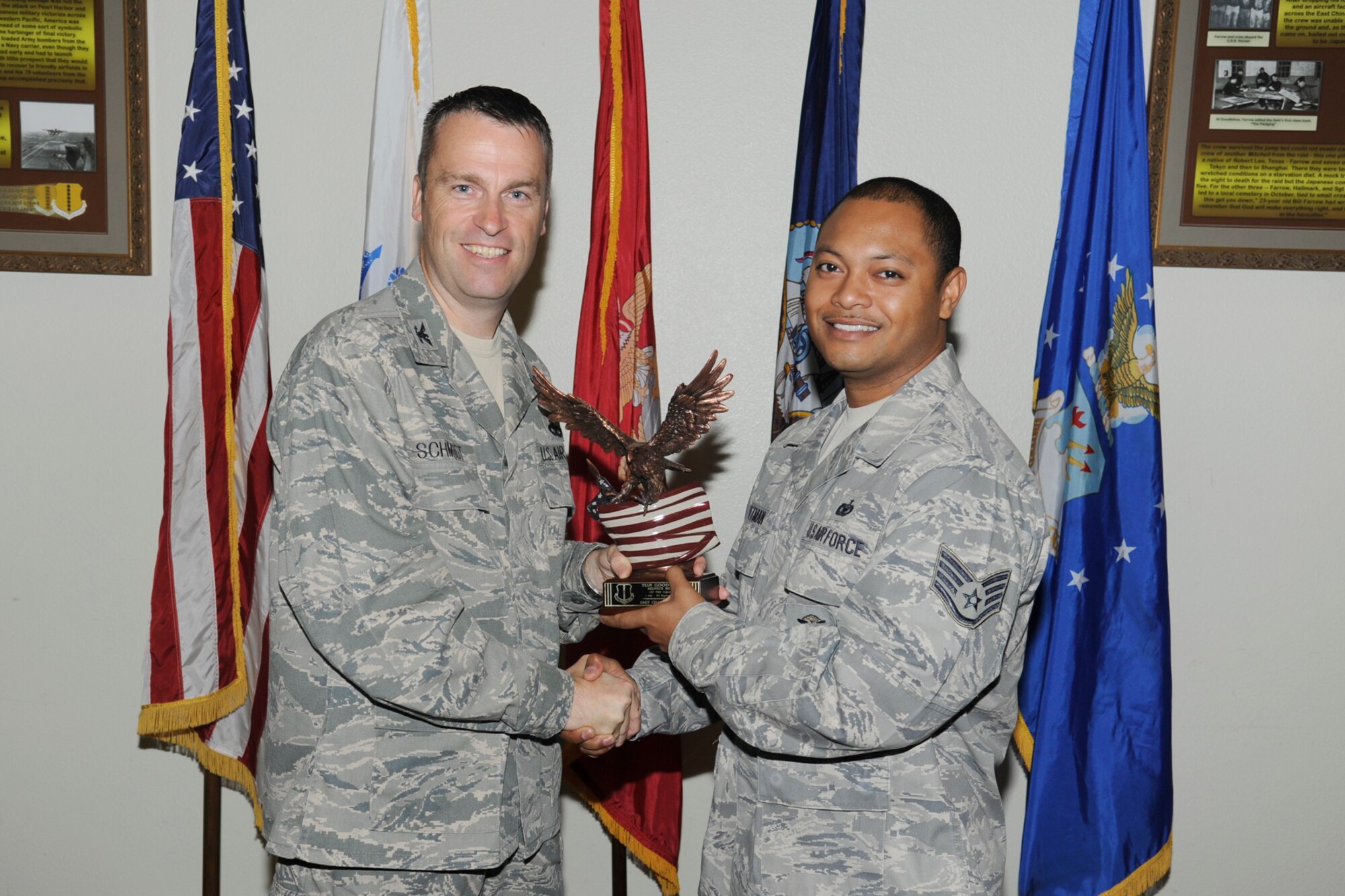 U.S. Air Force Col. Thomas Schmidt, 17th Training Wing (TRW) vice commander presents the Team Goodfellow Service Member of the Quarter to Staff Sgt. Chalom Pittman, 17th Security Forces Squadron, during the wing quarterly awards ceremony, Goodfellow Air Force Base, Texas, Oct. 23, 2012. (U.S. Air Force photo by Staff Sgt. Austin Knox)