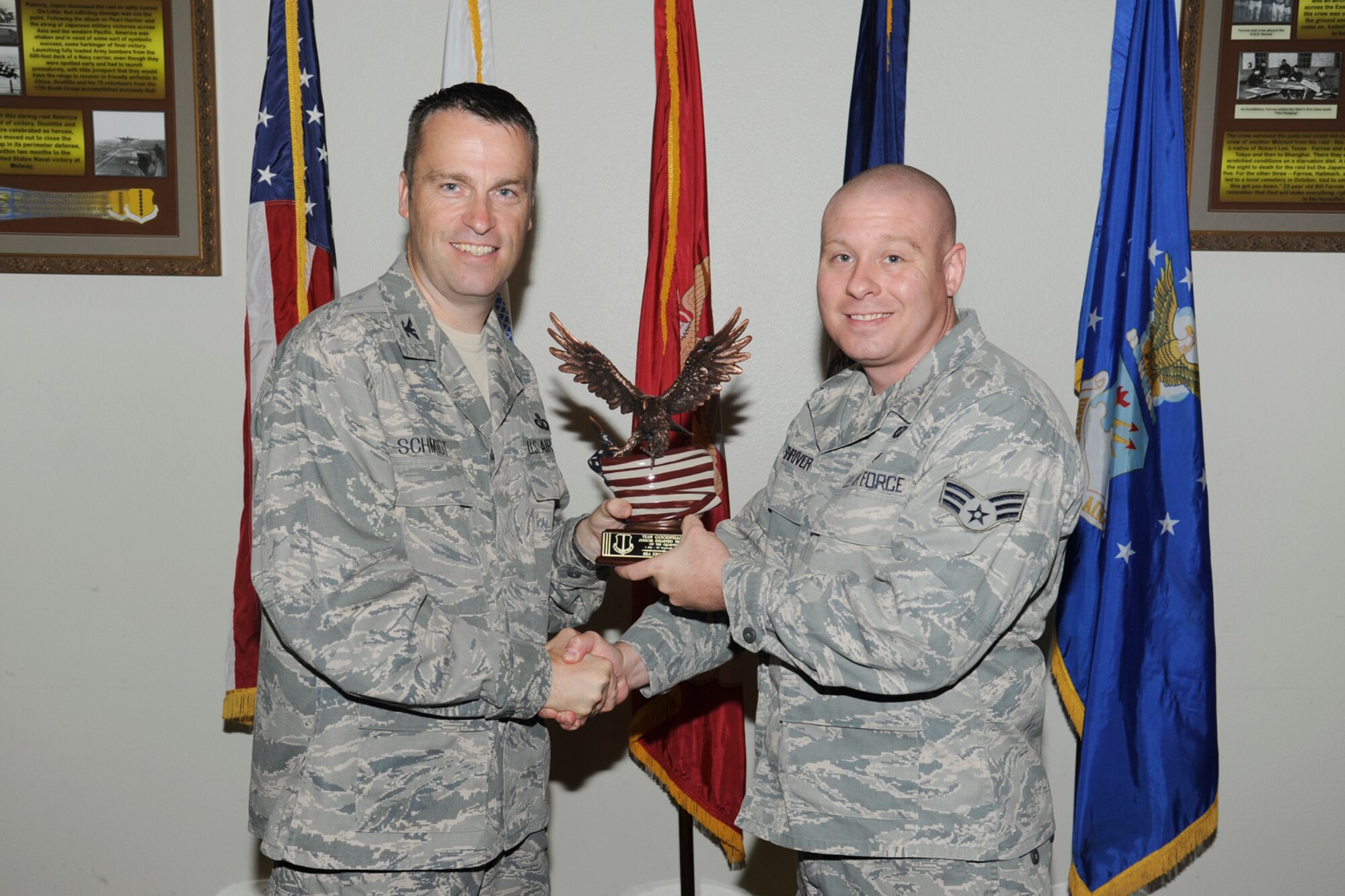 U.S. Air Force Col. Thomas Schmidt, 17th Training Wing (TRW) vice commander, presents the Team Goodfellow Junior Enlisted of the Quarter to Senior Airman Erick Shriver, 17th Contracting Squadron, during the wing quarterly awards ceremony, Goodfellow Air Force Base, Texas, Oct. 23, 2012. (U.S. Air Force photo by Staff Sgt. Austin Knox)