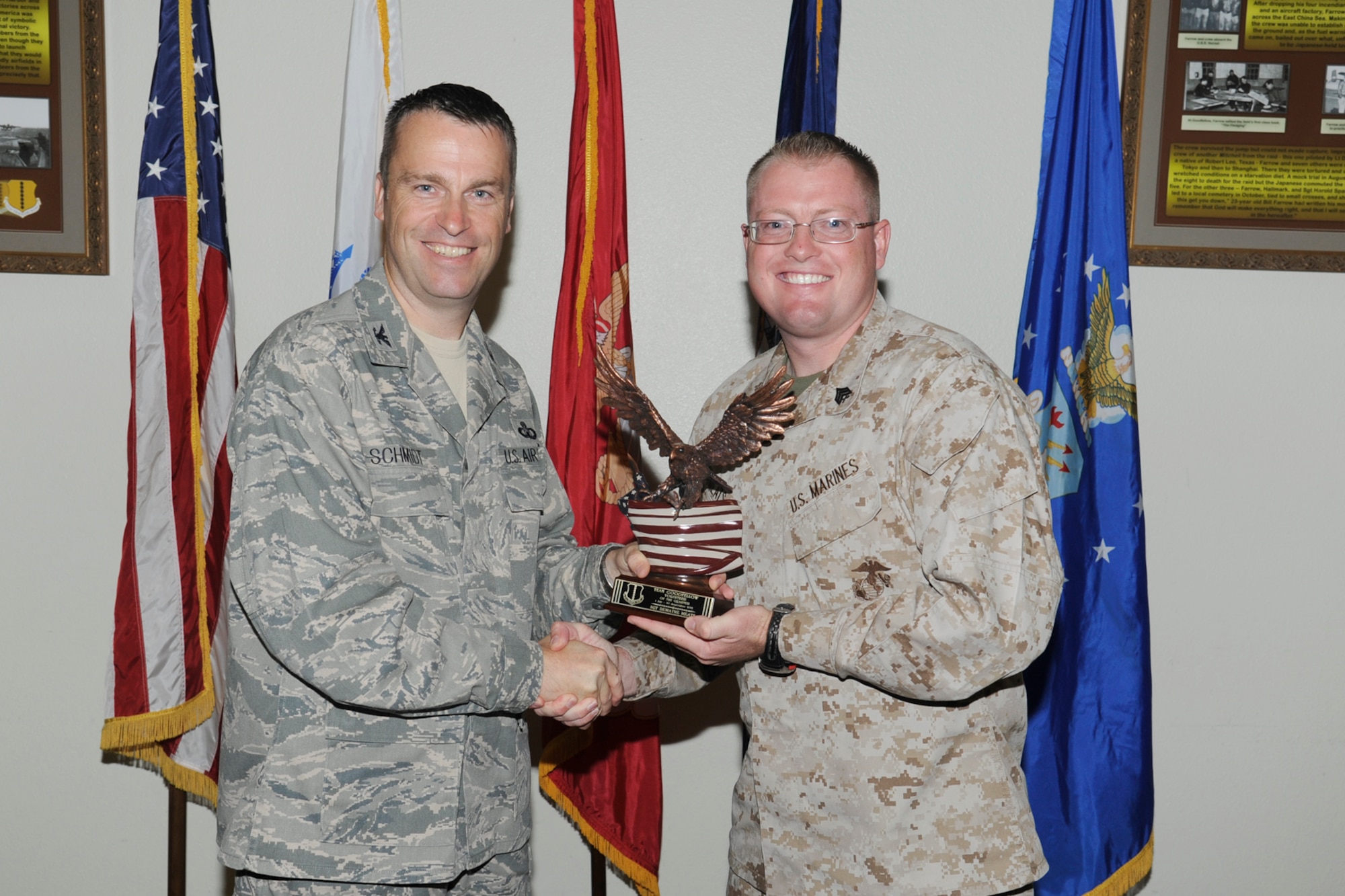 U.S. Air Force Col. Thomas Schmidt, 17th Training Wing (TRW) vice commander, presents the Team Goodfellow Volunteer of the Quarter to U.S. Marine Corps Sgt. Dewayne Meats, Marine Corps Detachment Goodfellow, during the wing quarterly awards ceremony, Goodfellow Air Force Base, Texas, Oct. 23, 2012. (U.S. Air Force photo by Staff Sgt. Austin Knox)