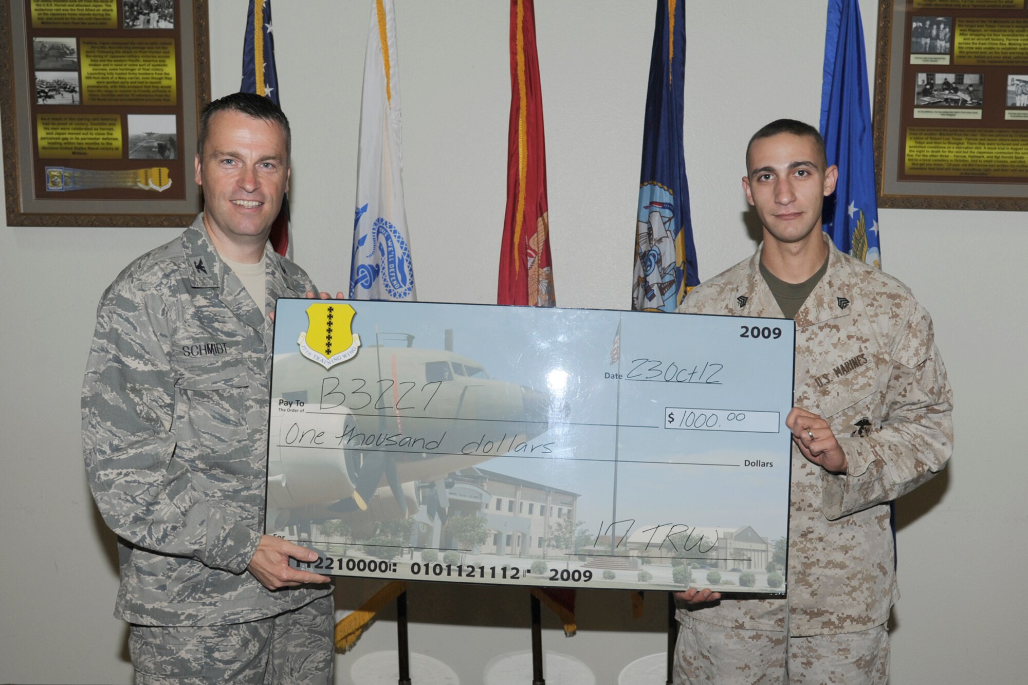 U.S. Air Force Col. Thomas Schmidt, 17th Training Wing (TRW) vice commander, presents U.S. Marine Corps Sgt. Alexander Garabedian, Marine Corps Detachment Goodfellow, with the Team Goodfellow, Goodfellow Air Force Base Dormitory of the Quarter, for B3227 during the wing quarterly awards ceremony, Goodfellow Air Force Base, Texas, Oct. 23, 2012. (U.S. Air Force photo by Staff Sgt. Austin Knox)