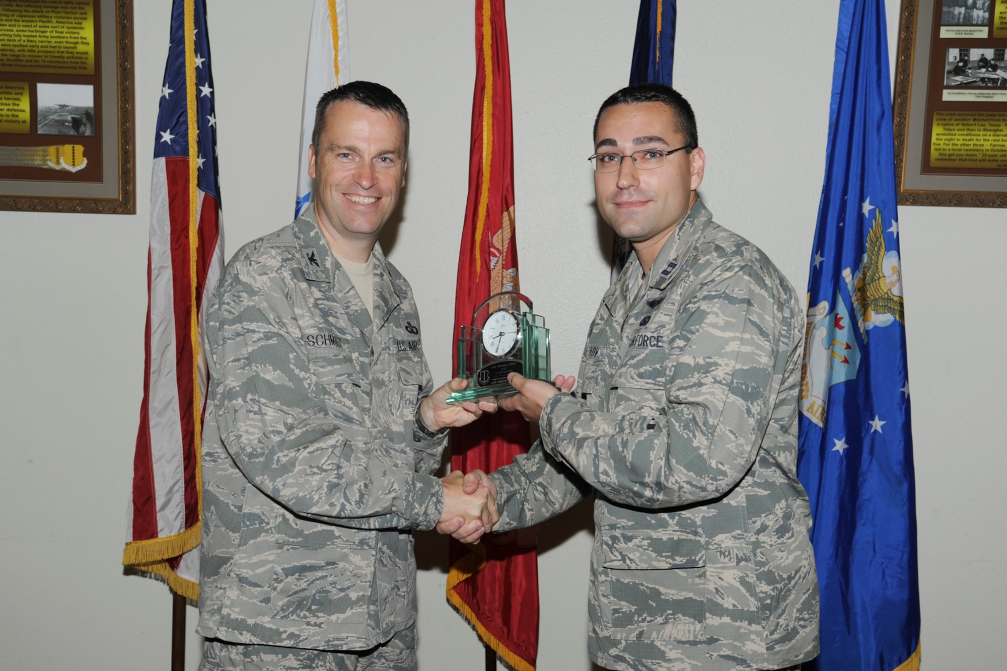 U.S. Air Force Col. Thomas Schmidt, 17th Training Wing (TRW) vice commander, presents the 17th Training Wing CGO of the Quarter to Capt Timothy Petrov, 316th Training Squadron, during the wing quarterly awards ceremony, Goodfellow Air Force Base, Texas, Oct. 23, 2012. (U.S. Air Force photo by Staff Sgt. Austin Knox)