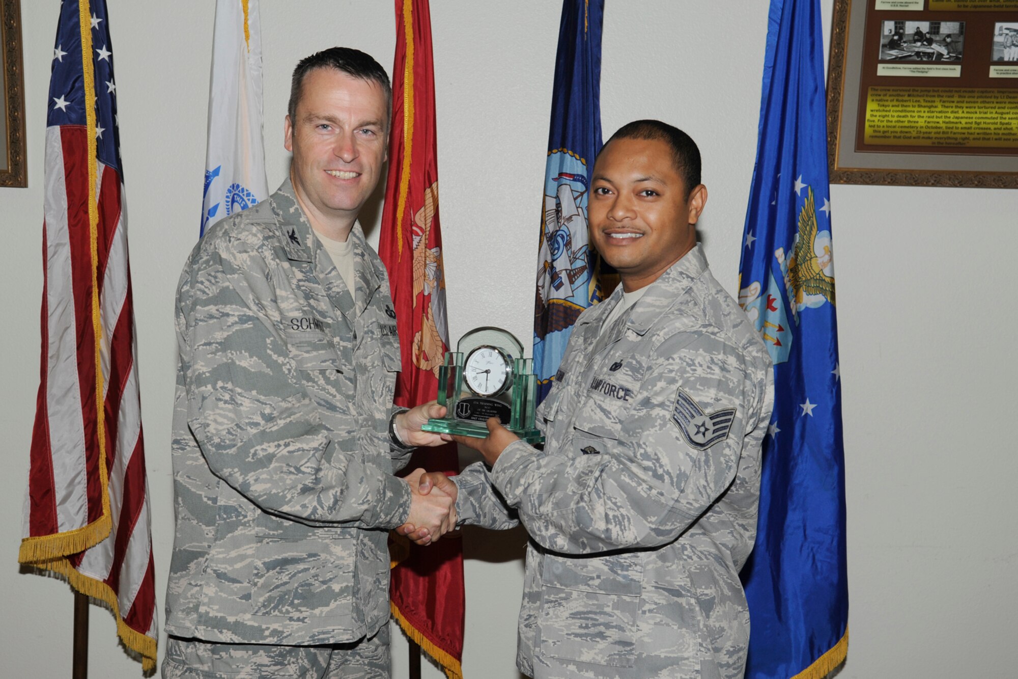 U.S. Air Force Col. Thomas Schmidt, 17th Training Wing (TRW) vice commander, presents the 17th Training Wing NCO of the Quarter to Staff Sgt. Chalom Pittman, 17th Security Forces Squadron, during the wing quarterly awards ceremony, Goodfellow Air Force Base, Texas, Oct. 23, 2012. (U.S. Air Force photo by Staff Sgt. Austin Knox)