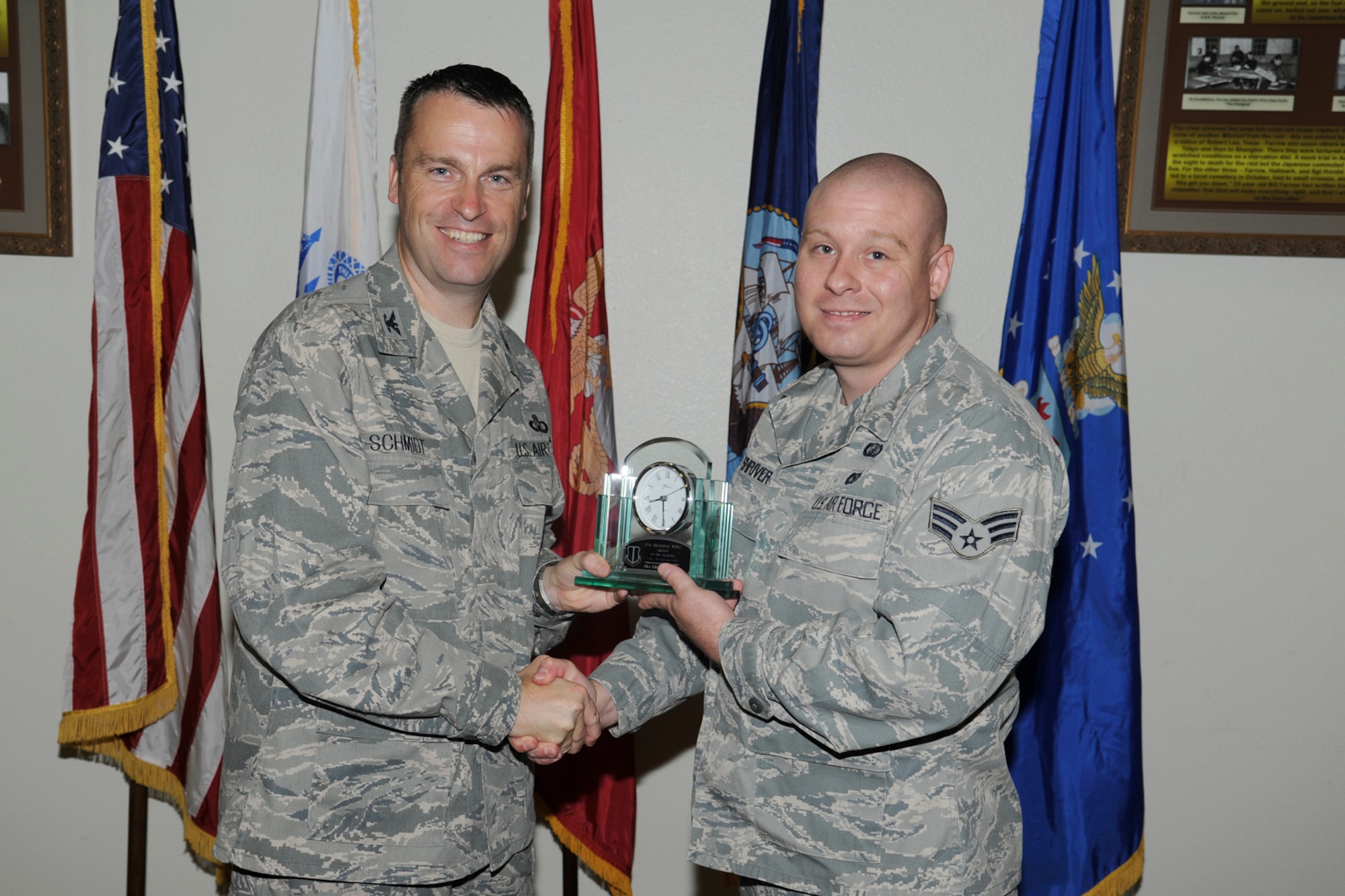 U.S. Air Force Col. Thomas Schmidt, 17th Training Wing (TRW) vice commander, presents the 17th Training Wing Airman of the Quarter to Senior Airman Erick Shriver, 17th Contracting Squadron, during the wing quarterly awards ceremony, Goodfellow Air Force Base, Texas, Oct. 23, 2012. (U.S. Air Force photo by Staff Sgt. Austin Knox)