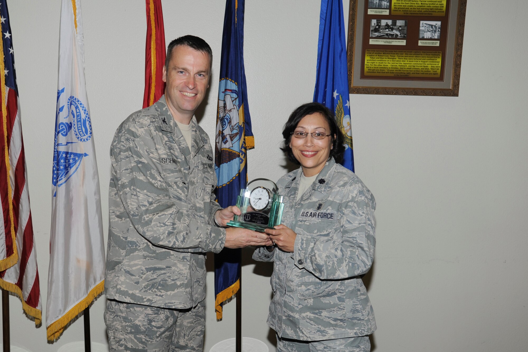 U.S. Air Force Col. Thomas Schmidt, 17th Training Wing (TRW) vice commander, presents the Team Goodfellow Unit of the Quarter to Lt. Col. Regina Agee, 17th Medical Operations Squadron commander, during the wing quarterly awards ceremony, Goodfellow Air Force Base, Texas, Oct. 23, 2012. The 17th Medical Operations Squadron also received the 17th TRW Unit of the Quarter. (U.S. Air Force photo by Staff Sgt. Austin Knox) 