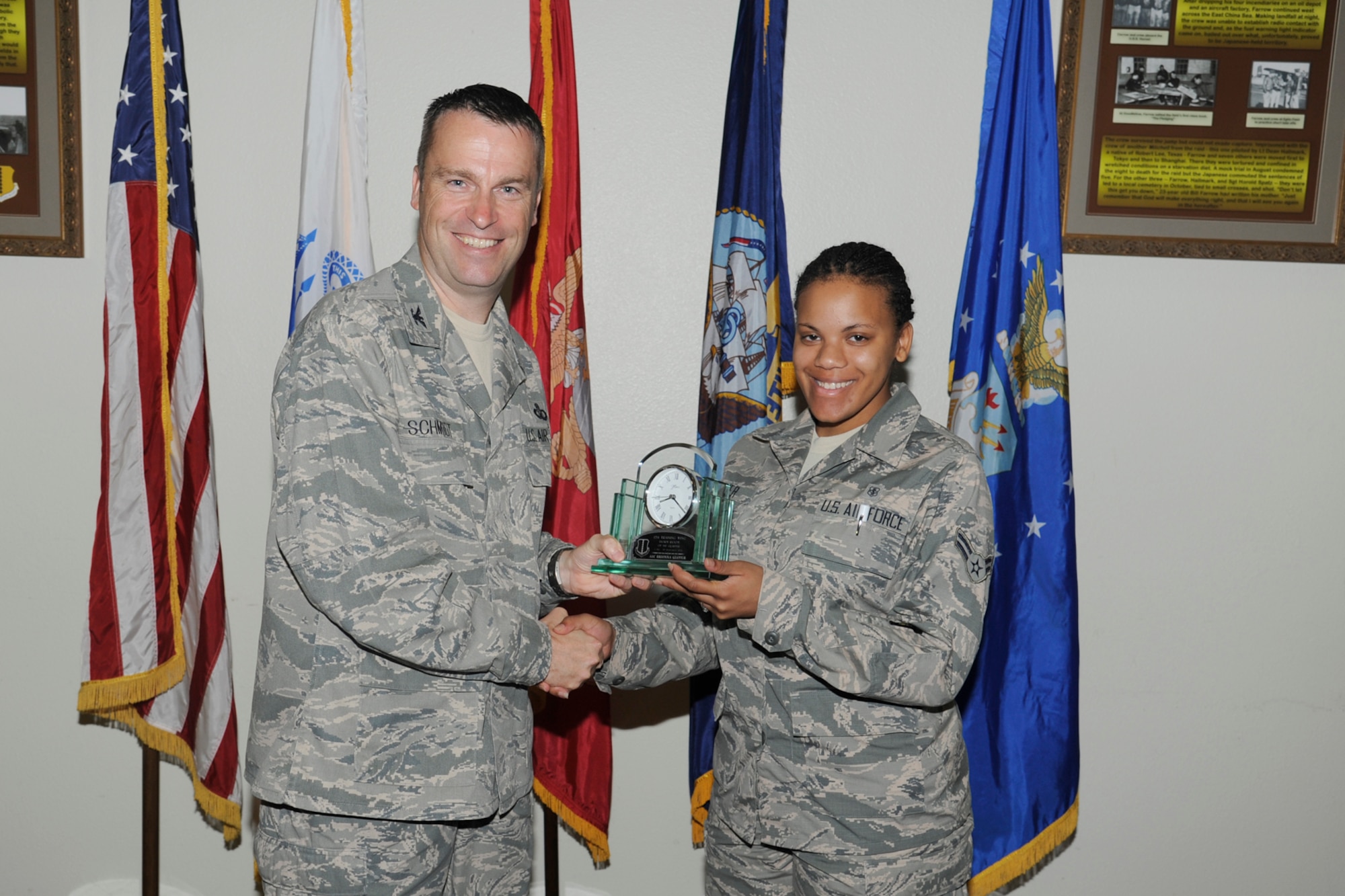 U.S. Air Force Col. Thomas Schmidt, 17th Training Wing (TRW) vice commander, presents the 17th Training Wing Dorm Room of the Quarter to Airman 1st Class Brionna Glover, 17th Medical Operations Squadron, during the wing quarterly awards ceremony, Goodfellow Air Force Base, Texas, Oct. 23, 2012. (U.S. Air Force photo by Staff Sgt. Austin Knox)