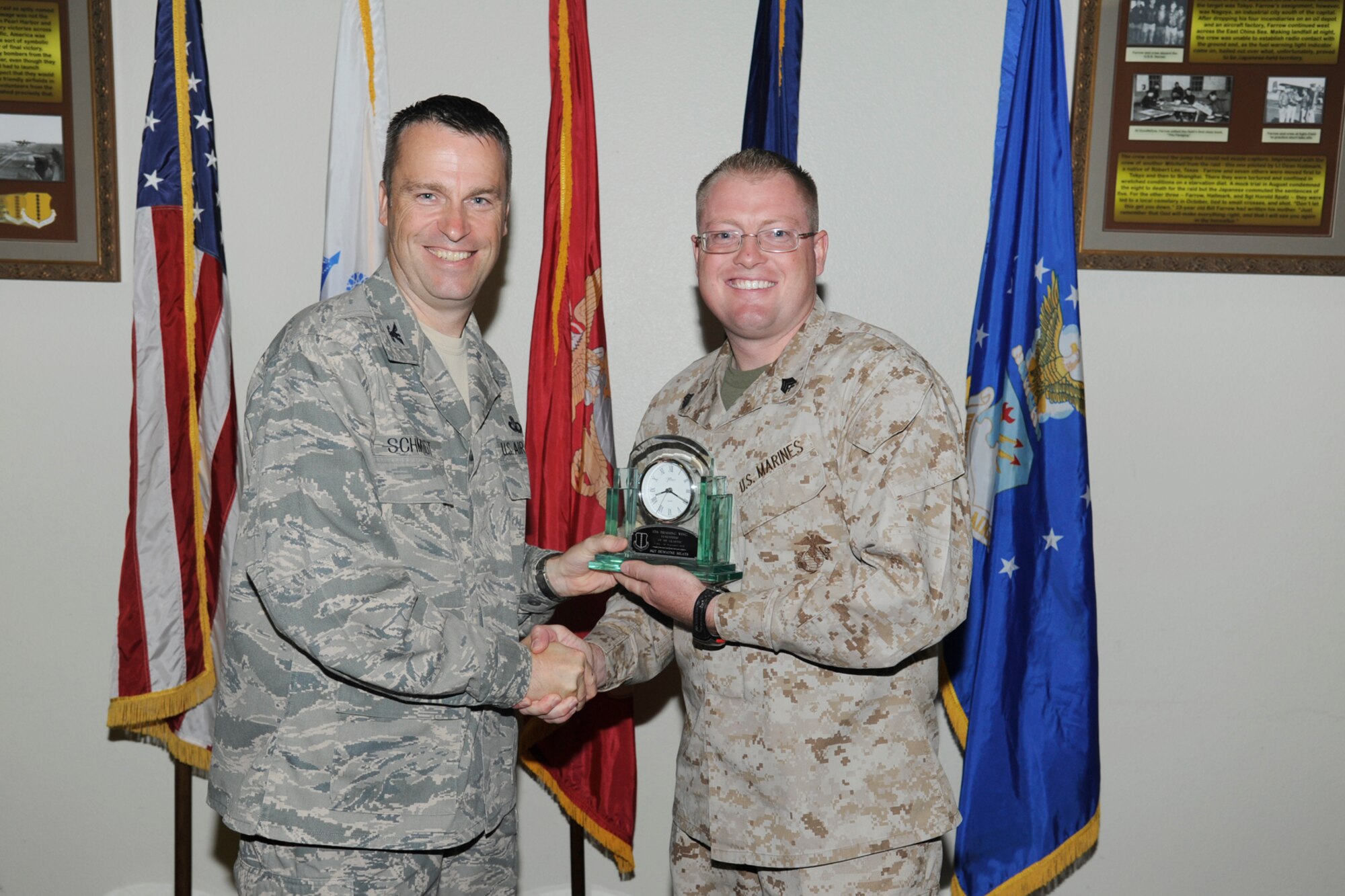 U.S. Air Force Col. Thomas Schmidt, 17th Training Wing (TRW) vice commander, presents the 17th Training Wing Volunteer of the Quarter to U.S. Marine Corps Sgt. Dewayne Meats, Marine Corps Detachment Goodfellow, during the wing quarterly awards ceremony Goodfellow Air Force Base, Texas, July 24, 2012. (U.S. Air Force photo by Staff Sgt. Austin Knox)
