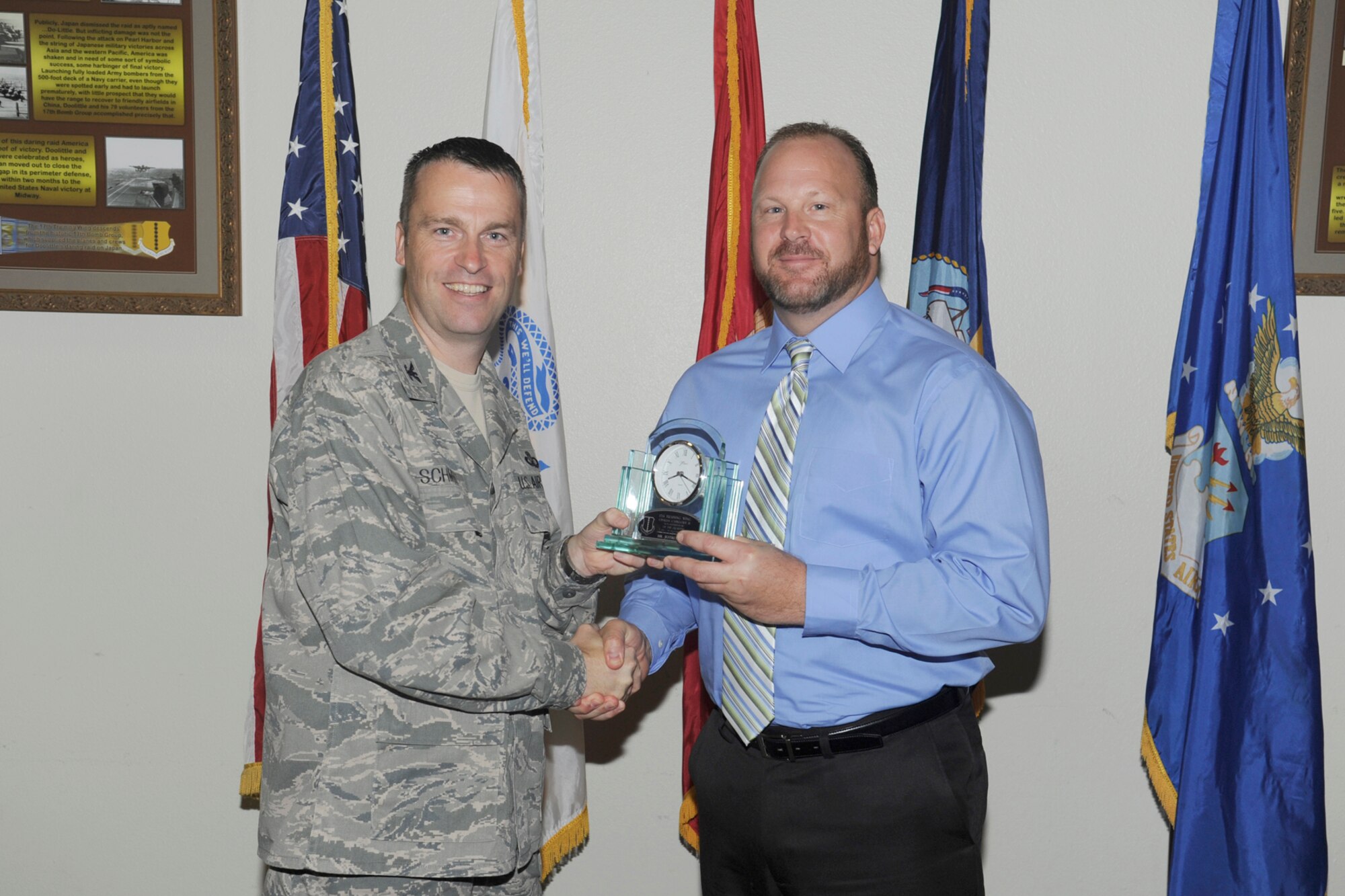 U.S. Air Force Col. Thomas Schmidt, 17th Training Wing (TRW) vice commander,  presents the 17th Training Wing Non-Supervisory Civilian of the Quarter Category II to Jeffrey Crim, 17th Communications Squadron, during the wing quarterly awards ceremony, Goodfellow Air Force Base, Texas, Oct. 23, 2012. (U.S. Air Force photo by Staff Sgt. Austin Knox)