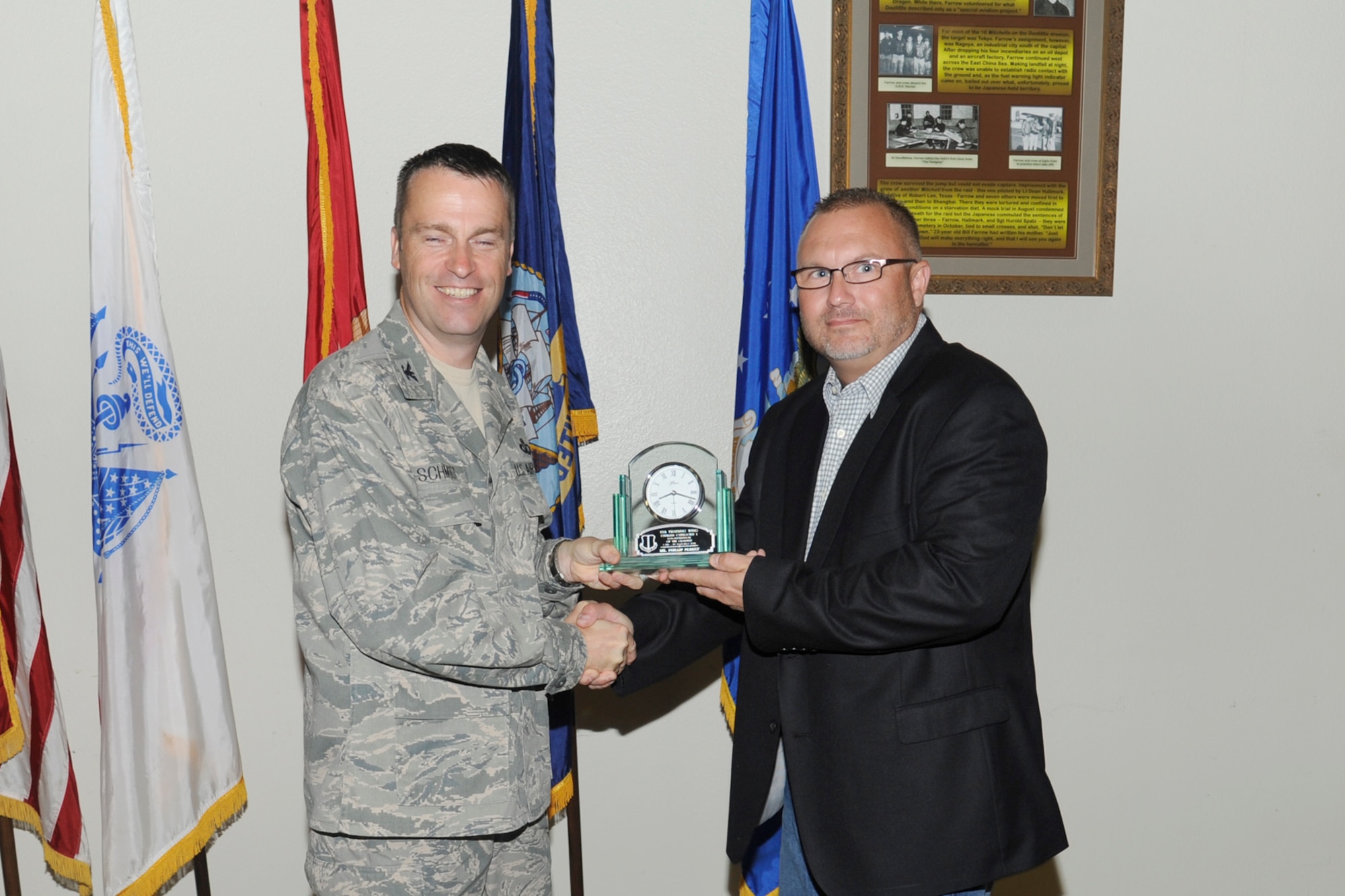 U.S. Air Force Col. Thomas Schmidt, 17th Training Wing (TRW) vice commander,  presents the 17th Training Wing Non-Supervisory Civilian of the Quarter Category I to Phillip Perkey, 17th Medical Group, during the wing quarterly awards ceremony, Goodfellow Air Force Base, Texas, Oct. 23, 2012. (U.S. Air Force photo by Staff Sgt. Austin Knox)
