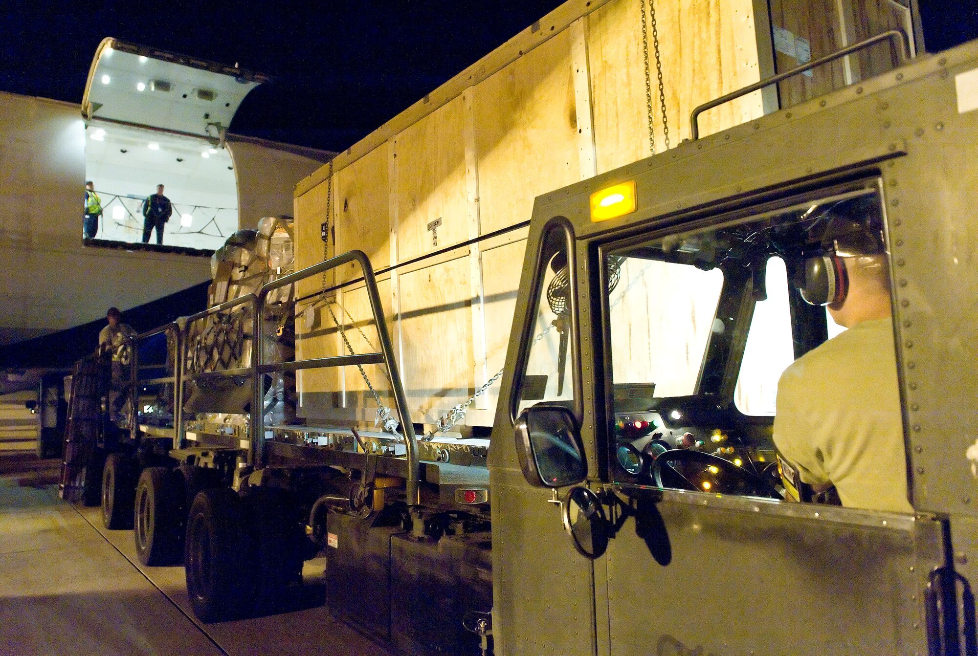 Senior Airman Russell Schemmel, a ramp operations specialist with the 436th Aerial Port Squadron, transfers cargo onto a k-loader Oct. 21, 2012, at Dover Air Force Base, Del. Schemmel and other aerial porters loaded palletized cargo onto a Boeing 747 aircraft during the night. (U.S. Air Force photo by Roland Balik)
