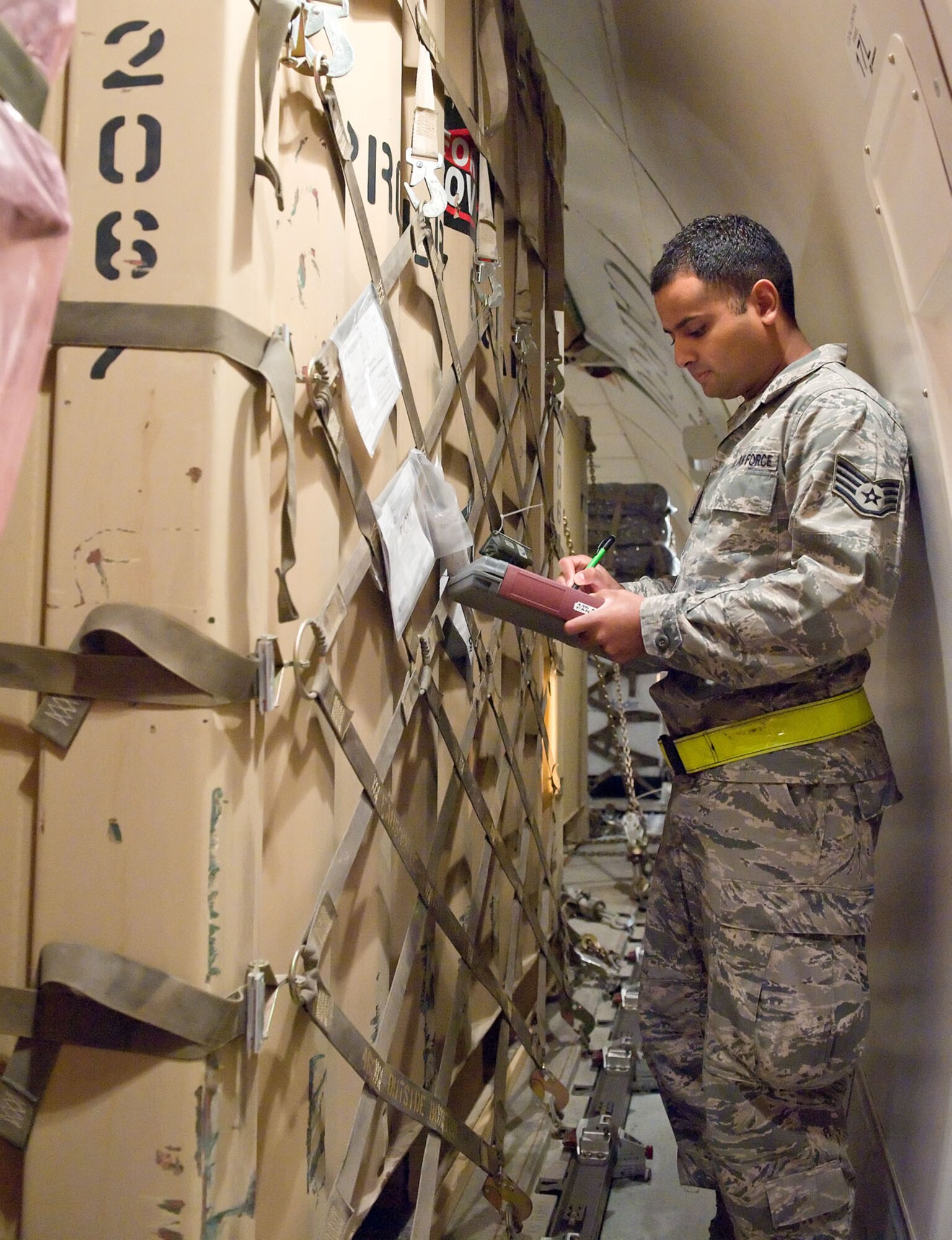 Staff Sgt. David Ramos, a shift ramp controller with the 436th Aerial Port Squadron, checks palletized cargo against the cargo manifest Oct. 21, 2012, at Dover Air Force Base, Del. During his shift, Ramos ensures that all inbound and outbound cargo is accounted for and properly manifested. (U.S. Air Force photo by Roland Balik)