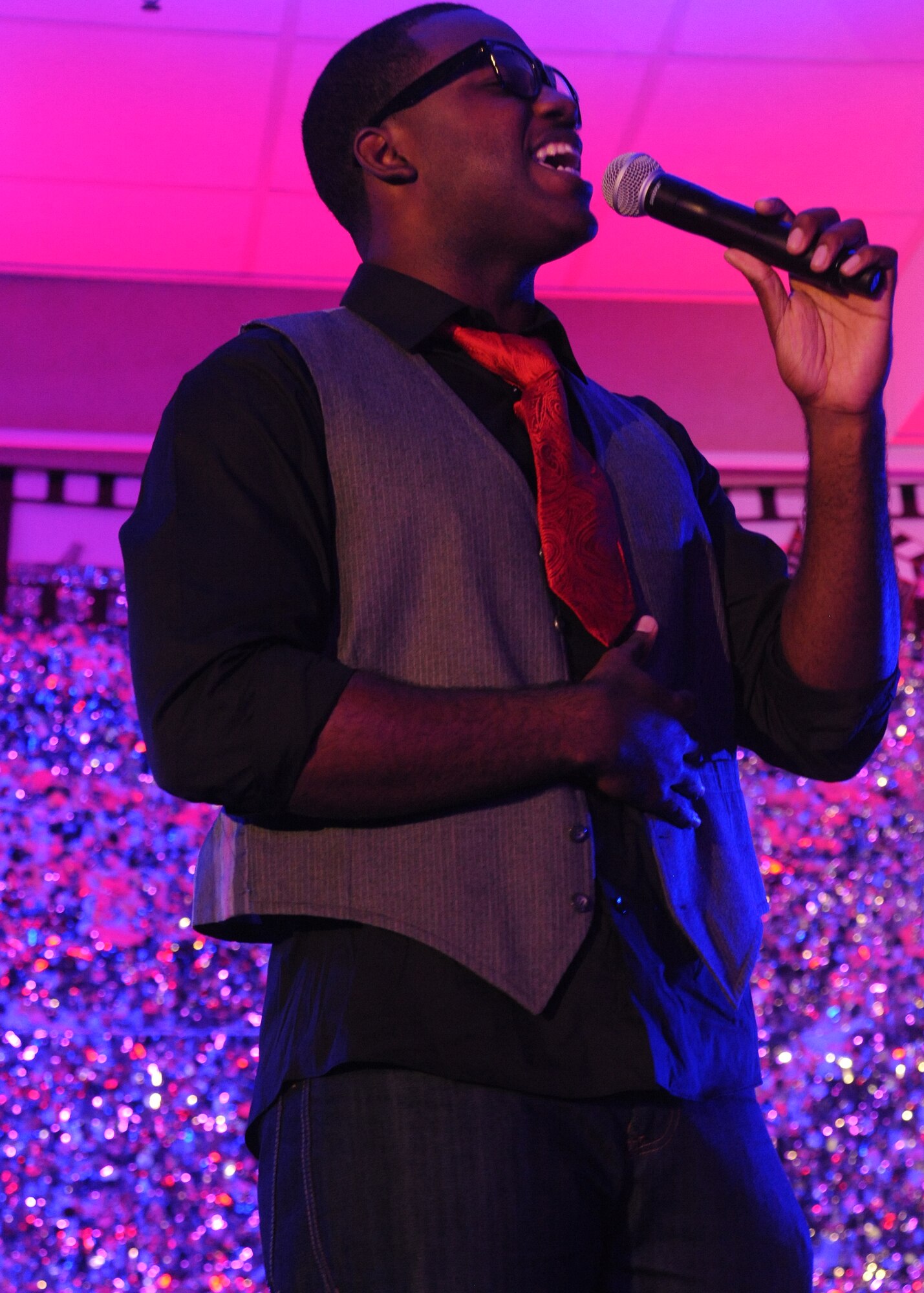Airman 1st Class Andrew Hicks, an aerospace medical technician with the 319th Medical Operations Squadron, performs for judges and guests attending the AMC Icon (base-level) singing competition, Aug. 16, 2012, at the Northern Lights Club on Grand Forks Air Force Base, N.D. Hicks will represent Grand Forks AFB at the AMC Icon (major command-level) singing contest at Scott AFB, Ill., Oct. 25, 2012.  Based loosely on the television show "American Idol," AMC Icon is an AMC commander's initiative to showcase the vocal talents of Air Mobility Command Airmen. Each AMC base holds Icon contests in July and August to determine their representatives for the final competition, which takes place at Scott AFB, Ill. Hicks, a 24-year-old native from Colorado Springs, Colo., said performing at the event means a lot to him. He described it as an opportunity to represent not only his base and unit, but his family and my hometown as well. (U.S. Air Force photo/Airman 1st Class Xavier Navarro)