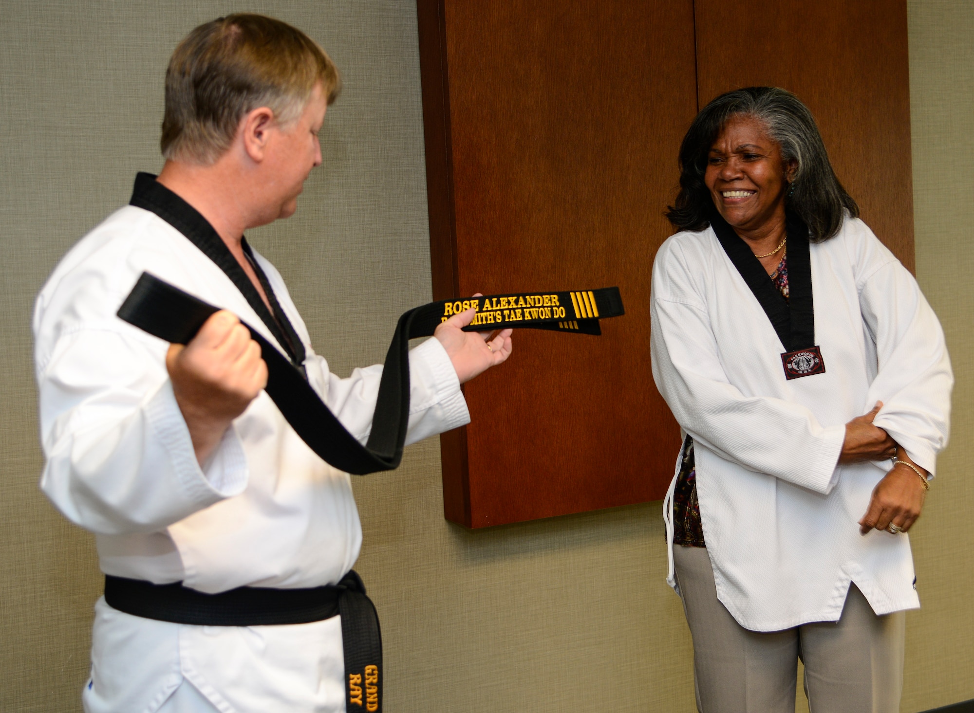 Grand Master Ray Smith, 8th degree Taekwondo black belt, presents an honorary fourth degree black belt to Rose Alexander, 628th Air Base Wing chief of external information at Joint Base Charleston – Air Base, S.C. October 22, 2012. Previously, only South Carolina governors Jim Hodges and Mark Sanford have been recognized by the USA Taekwondo Assoc.  (U.S. Air Force photo / Staff Sgt. Rasheen Douglas)