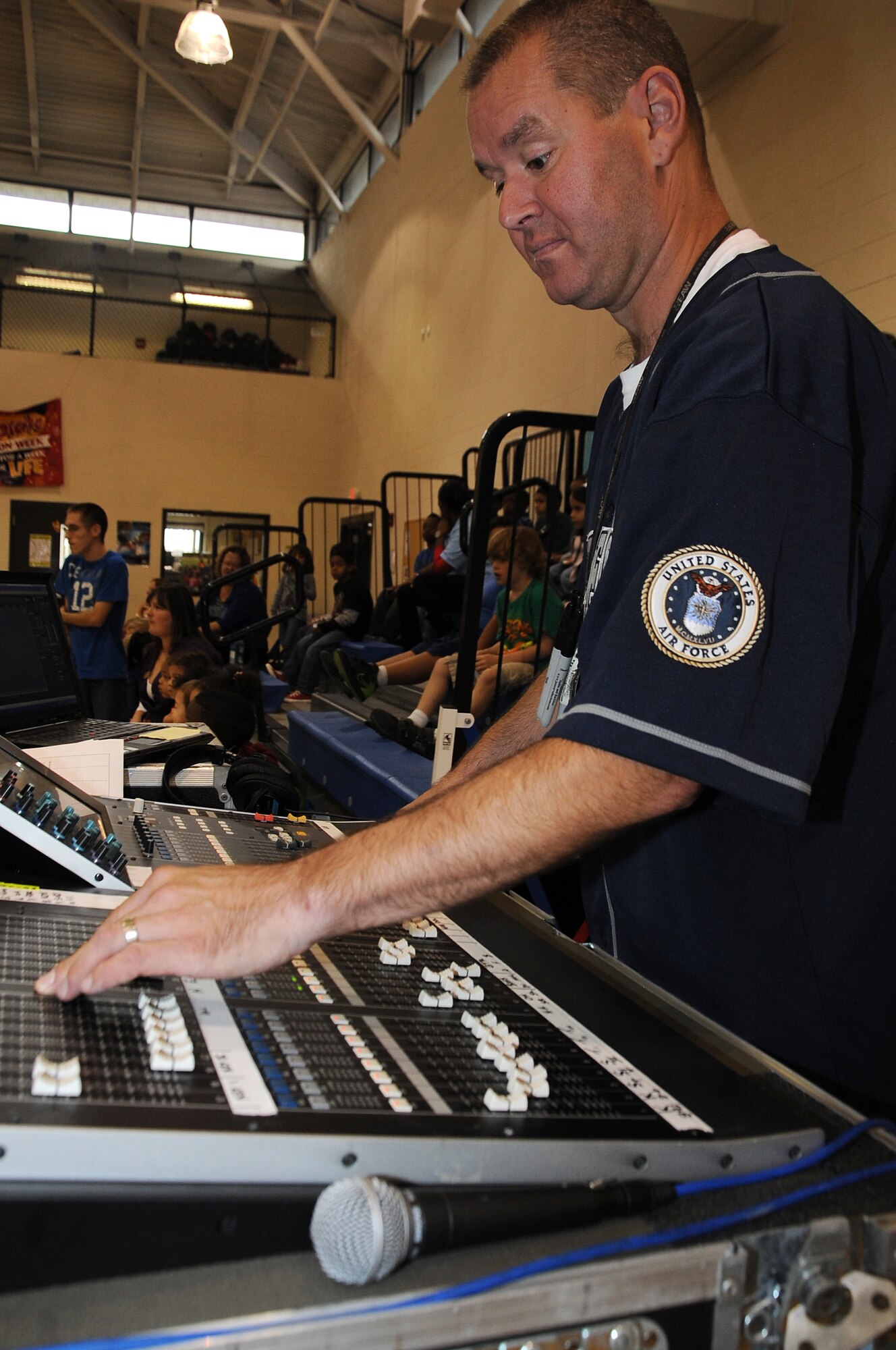 U.S. Air Force Staff Sgt. Brad Femiak, Blue Aces audio engineer, adjusts settings on a soundboard at the youth center on Seymour Johnson Air Force Base, N.C., Oct. 17, 2012. The soundboard controls the different levels and dynamics for audio signals of the instruments during the concert. (U.S. Air Force photo/Airman 1st Class John Nieves Camacho/Released)