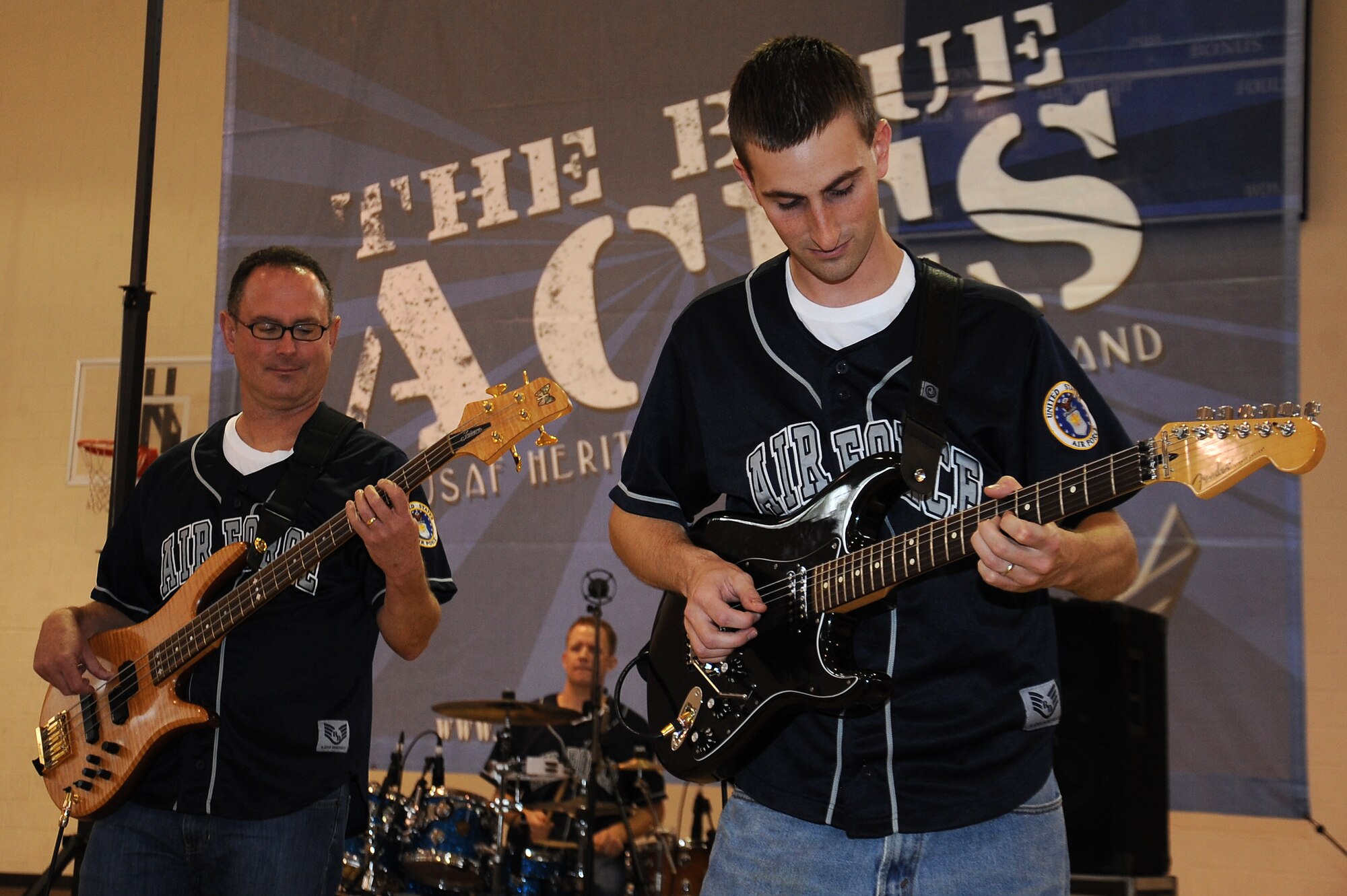 U.S. Air Force Senior Airman Aaron Weibe, Blue Aces guitarist (right), and Master Sgt. Kenny Maurais, Blue Aces bassist, perform during a concert at the youth center on Seymour Johnson Air Force Base, N.C., Oct. 17, 2012. The band consists of one bassist, two electric guitarists, a drummer and vocalist. (U.S. Air Force photo/Airman 1st Class John Nieves Camacho/Released)