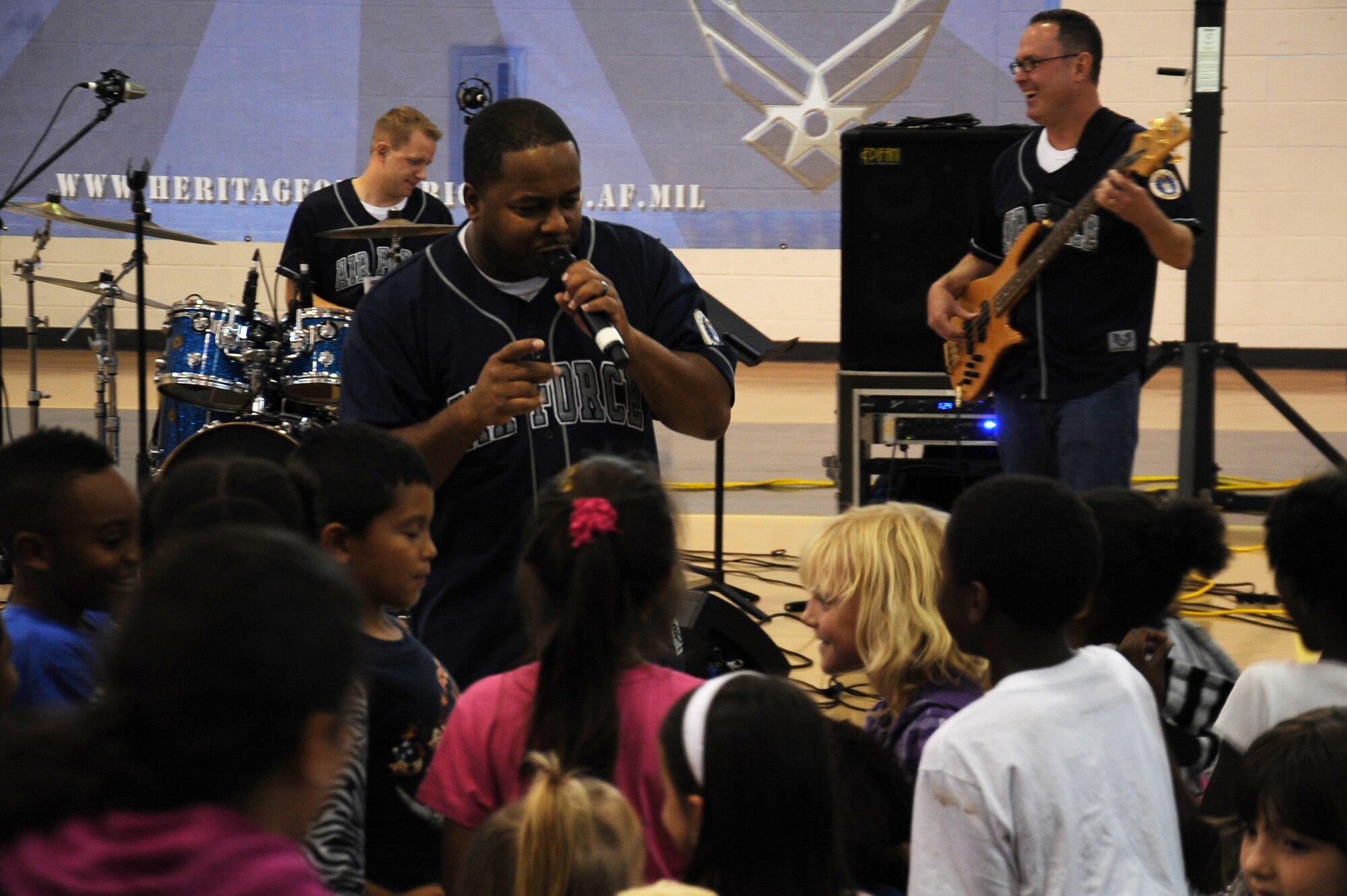 U.S. Air Force Tech. Sgt. Niko Ellison, Blue Aces vocalist, sings to a group of children at the youth center on Seymour Johnson Air Force Base, N.C., Oct. 17, 2012. Band members got the crowd on their feet singing and dancing. (U.S. Air Force photo/Airman 1st Class John Nieves Camacho/Released)