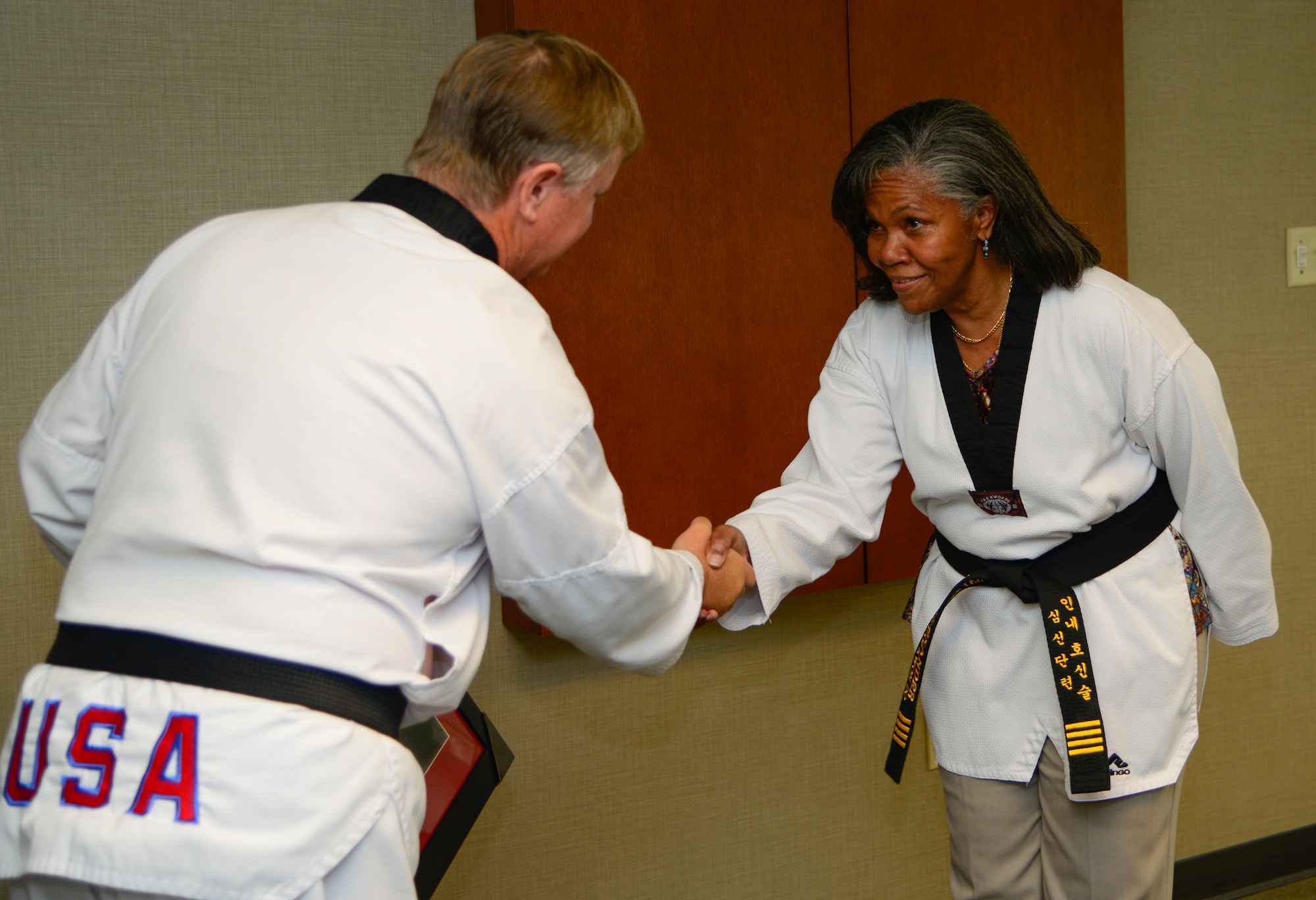 Rose Alexander, 628th Air Base Wing chief of external information, accepts her honorary black belt from Grand Master Ray Smith, 8th degree Taekwondo black belt, at Joint Base Charleston – Air Base, S.C. Oct. 22, 2012. Alexander’s son, Charles Alexander, is a nationally recognized Taekwondo black belt and her grandson, Alexander Cheatham, although legally blind, has excelled in Taekwondo . (U.S. Air Force Photo / Staff Sgt. Rasheen Douglas)
