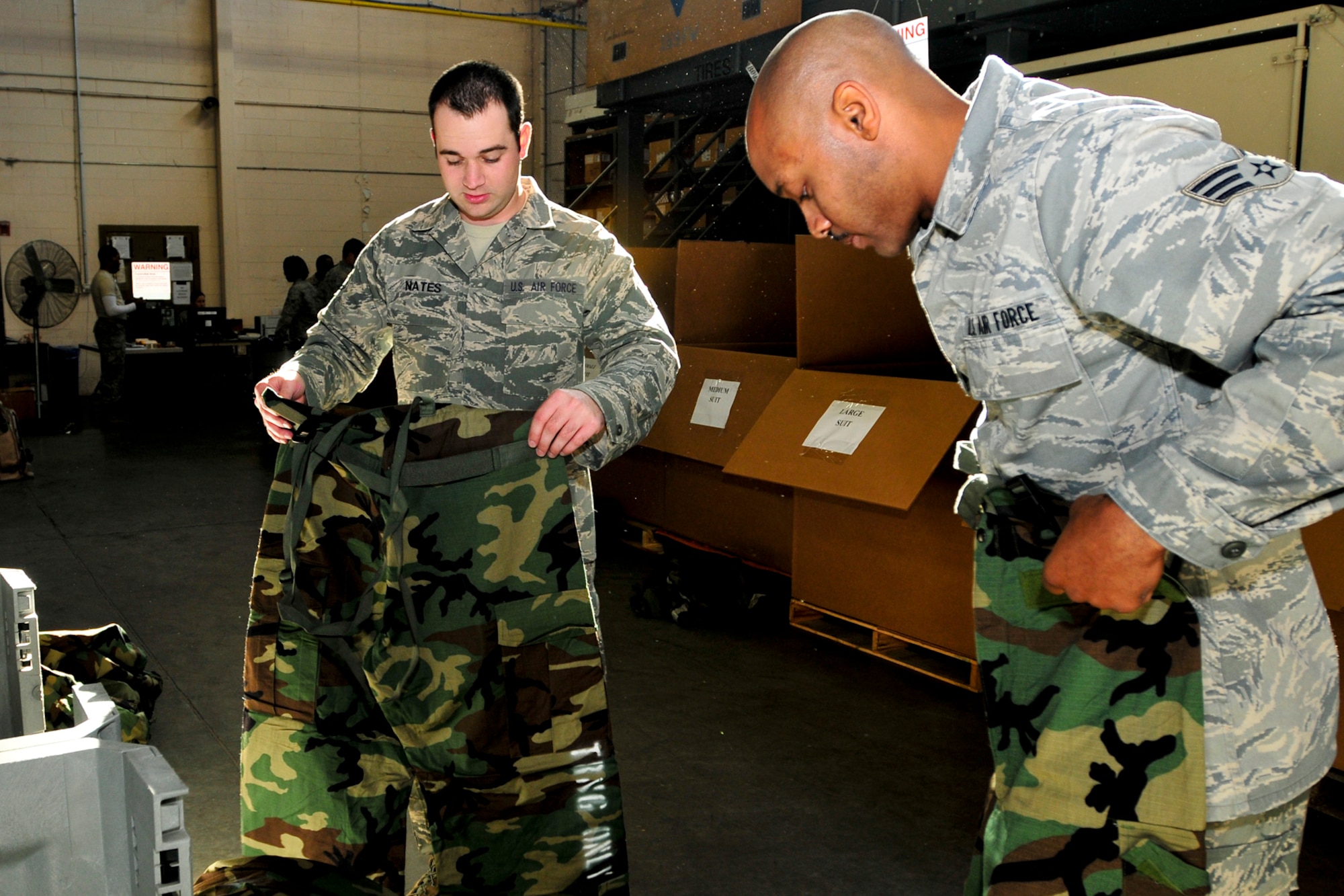Senior Airmen Anthony Fields and Johnny Nates, 169th Maintenance Squardon, check for proper fit of thier new Joint Service Lightweight Integrated Suit Technology (JLIST), McEntire Joint National Guard Base, S.C., Oct. 13, 2012.  The old Battle Dress Overgarment (BDO) and gas mask are being phased out to introduce the new JLIST and M50 before the wing begins training for their Operation Readiness Inspection. (National Guard photo by Staff Sgt. Jorge Intriago/Released) 