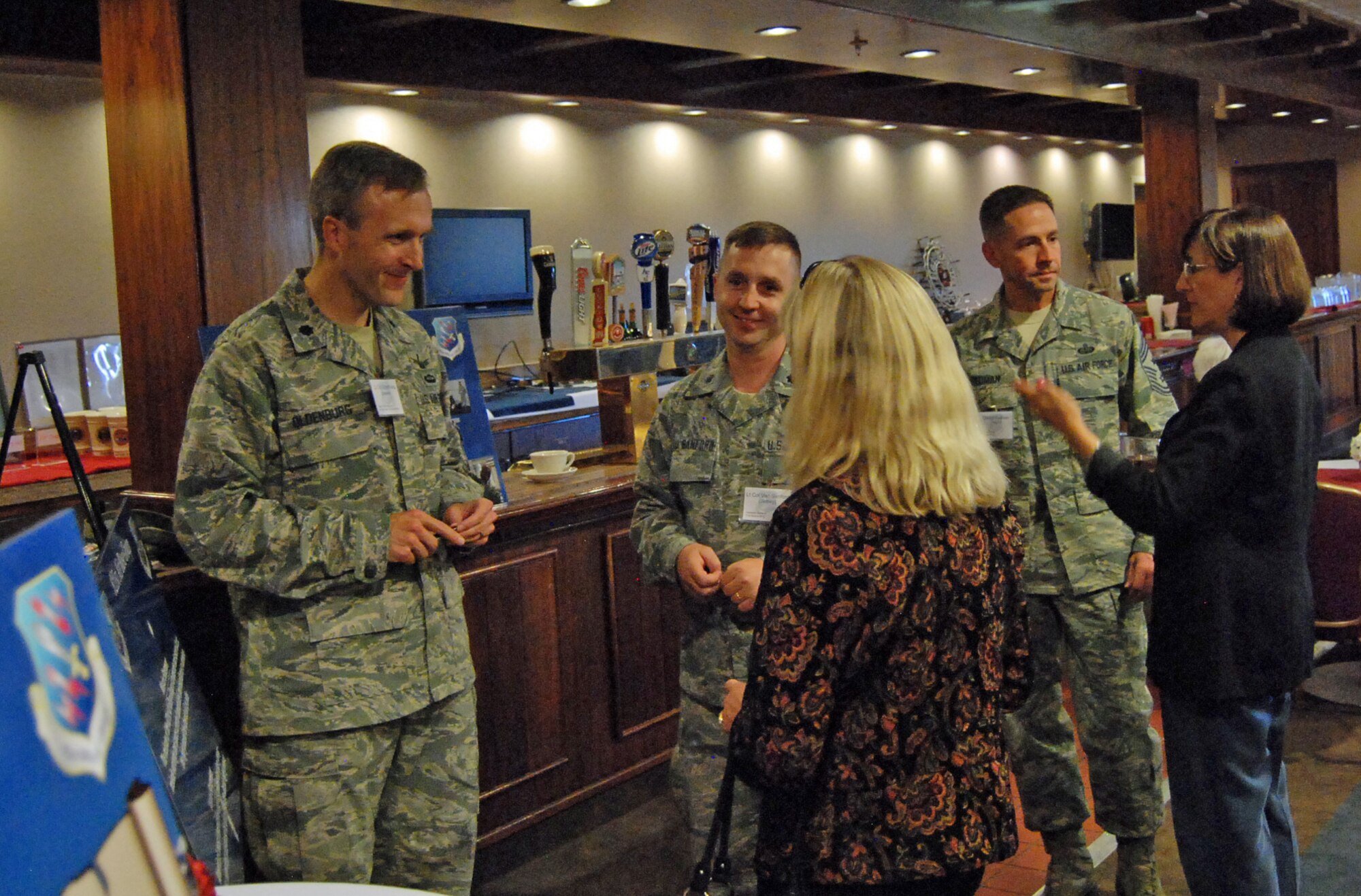 PETERSON AIR FORCE BASE, Colo. -- Lt. Col. James Oldenburg (left), 21st Space Wing chief of plans, programs and exercises, Lt. Col. Jeffrey Vansanford, 21st SW inspector general, and Chief Master Sgt. Richard Redman, 21st SW command chief, greet civic leaders from the local area Oct. 16, during the 21st SW’s Commander State of the Wing and Civic Social in The Club here. The event educated key civic leaders in the Pikes Peak region on the wing’s mission, operational capabilities, and vitality indicators for present and future development. Civic leaders in attendance ranged from federal Congressional staff members, city and county elected officials, to prominent business and educational leaders within the community. (U.S. Air Force photo/Senior Airman Jacob Morgan)