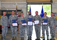 Flanked by Lt. Gen. Eric Fiel, commander of Air Force Special Operations Command, left, and Chief Master Sgt. William Turner, AFSOC‘s command chief, five of the 919th Special Operations Wing’s newest Promotion Enhancement Program promotees display their certificates Oct. 14 at Duke Field, Fla.  From left are Senior Master Sgts. Steve Bicknell, Angelia Fogle and Derrick Richardson, and Master Sgts. Christiaan Becker and Charles Presley.  Not shown:  Chief Master Sgt. Darlene Peterson and Master Sgt. Greg Lobman.  The PEP is a commander’s program designed to promote outstanding and well-deserving enlisted reservists who clearly demonstrate the ability to serve in the next higher grade.  (U.S. Air Force photo/Tech. Sgt. Cheryl Foster) 