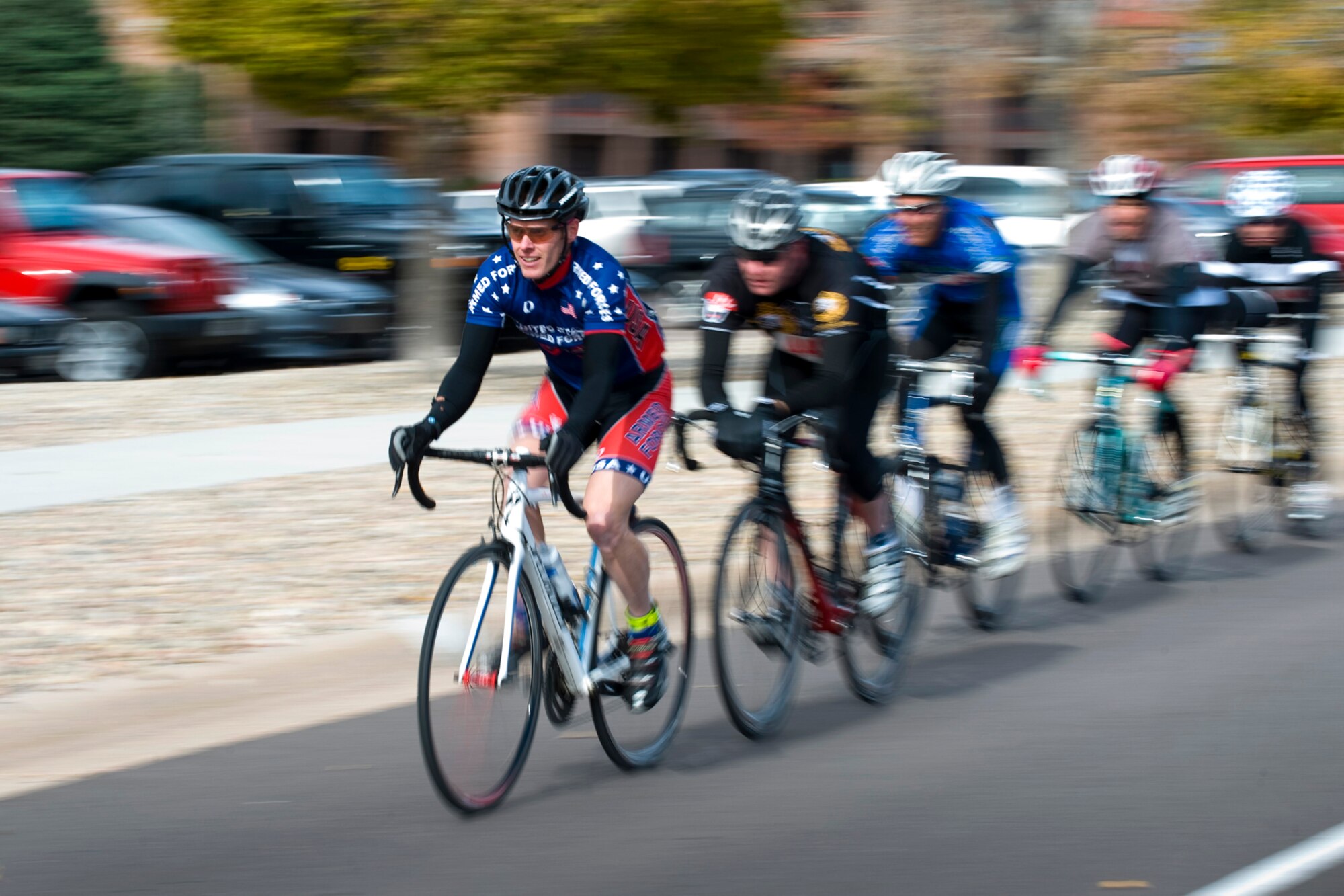 PETERSON AIR FORCE BASE, Colo. – Capt. Ian Holt, 16th Space Control Squadron, leads the way in the 10K Bike Race at the Peterson sports and field day Oct. 12. Holt went on to place first in the event. The 21st Force Support Squadron arranged various sporting events around base including golf, poker, swimming, running, cycling, volleyball and more, along with a free lunch at Eagle Park complete with entertainment and vendors. Winners included: Small group – 544th Intelligence, Surveillance and Reconnaissance Group; Medium group – AFSPC Inspector General; Large group – Team Colorado. (U.S Air Force photo/Craig Denton)