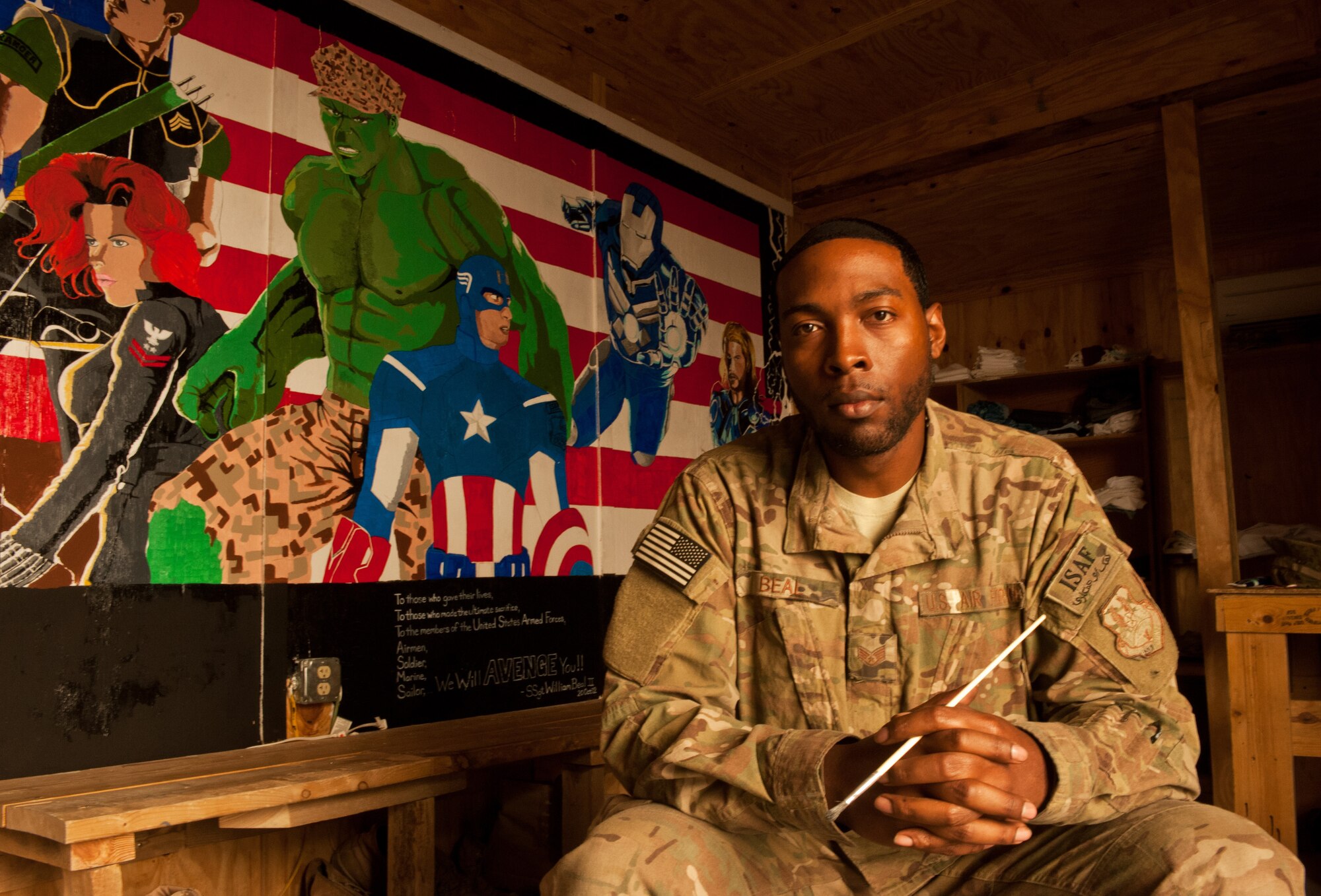 Staff Sgt. William Beal, an Airman assigned to 455th Expeditionary Logistics Readiness Squadron, pauses for a photo after finishing an “Avengers”-themed mural at the “Airman’s Attic” at Bagram Airfield, Afghanistan, Oct. 19, 2012. Beal volunteered his time and artistic talent to add this special detail to the “attic.” (U.S. Air Force Photo/SSgt Jeff Nevison)