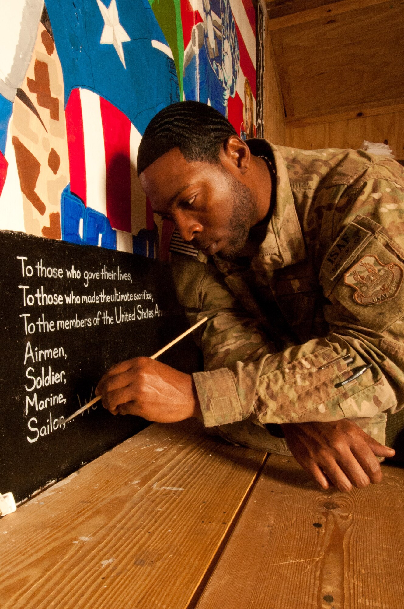 Staff Sgt. William Beal, an Airman assigned to 455th Expeditionary Logistics Readiness Squadron, finishes  a dedication on an “Avengers”-themed mural he painted at the “Airman’s Attic” at Bagram Airfield, Afghanistan, Oct. 23, 2012. Beal volunteered his time and artistic talent to add this special detail to the “attic.” (U.S. Air Force Photo/SSgt Jeff Nevison)