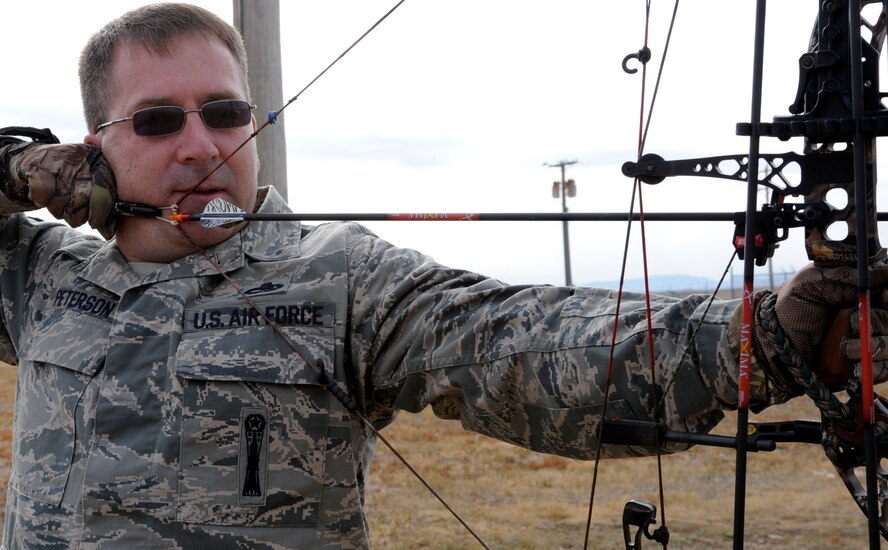 Chief Master Sgt. Kevin Peterson, 28th Bomb Wing command chief, demonstrates safe archery techniques while aiming an arrow at a target on the 28th Force Support Squadron trap and skeet range at Ellsworth Air Force Base, S.D., Oct. 11, 2012. Peterson stressed that safety is the most important aspect of all hunting activities. (U.S. Air Force photo by Airman Ashley J. Woolridge/Released)
