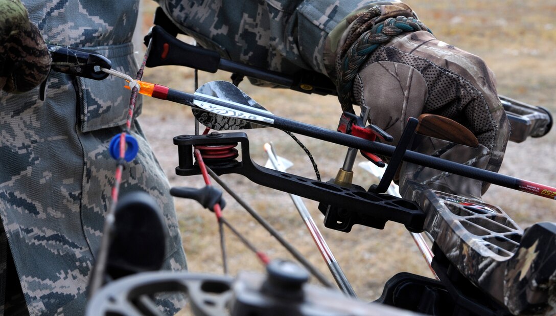 Chief Master Sgt. Kevin Peterson, 28th Bomb Wing command chief, nocks an arrow while practicing at the 28th Force Support Squadron trap and skeet range on Ellsworth Air Force Base, S.D., Oct. 11, 2012. Hunters should control the direction of their gun muzzle or arrow at all times to avoid turning a fun activity into a potential tragedy. (U.S. Air Force photo by Airman Ashley J. Woolridge/Released)