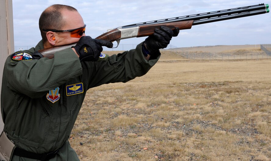 Col. Gentry Boswell, 28th Bomb Wing vice commander, takes aim at a clay pigeon while demonstrating safe hunting techniques at the 28th Force Support Squadron trap and skeet range at Ellsworth Air Force Base, S.D., Oct. 11, 2012. The use of eye and ear protection is required at all firing ranges, and wearing at least one blaze orange exterior garment is required when hunting most game with a firearm in South Dakota. (U.S. Air Force photo by Airman Ashley J. Woolridge/Released) 