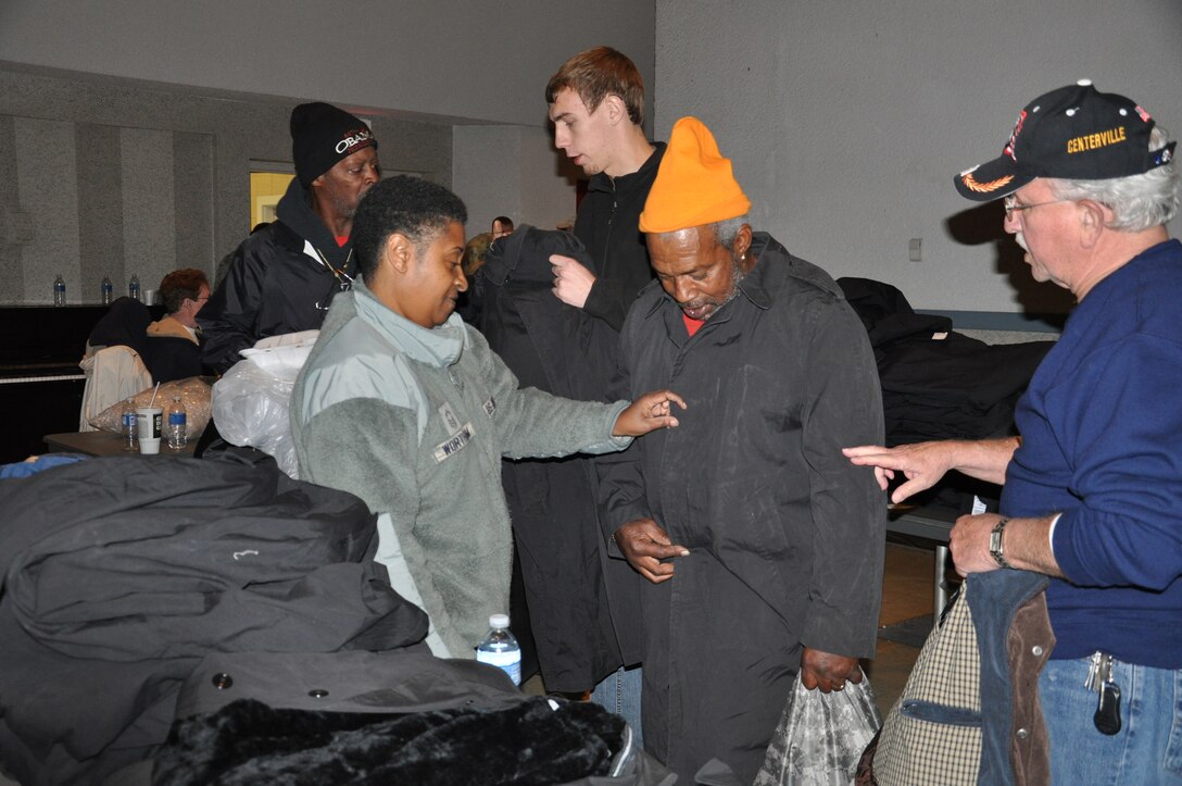 WRIGHT-PATTERSON AIR FORCE BASE, Ohio - Senior Master Sgt. Patricia Wortham, 445th Force Support Squadron personnel support for contingency operations chief, helps a veteran find the proper size coat during the 2012 Dayton Veteran’s Affairs Homeless Stand Down Oct. 19 held at the Dayton VA Medical Center. More than 20 volunteers from the wing along with the VA staff helped more than 300 homeless veterans by handing out donated clothing items and visiting with the men and women that came through the line. (U.S. Air Force photo/Lt. Col. Cynthia Harris)
