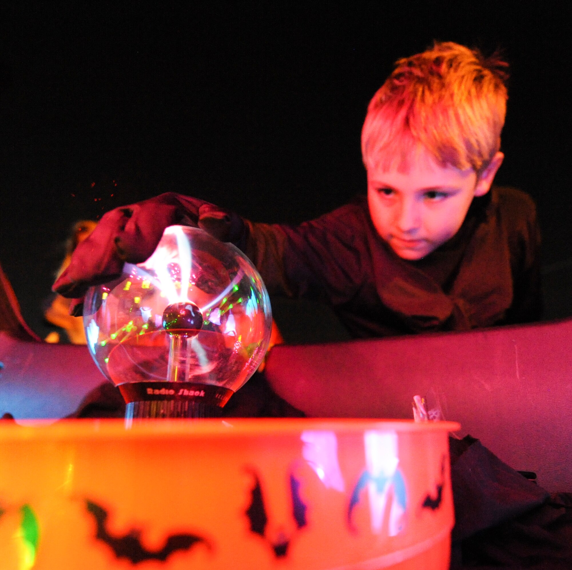 Dylan Smith, 9, son of Maj. Daryl Smith, a 41st Airlift Squadron pilot, touches a plasma globe during a trunk or treat event Oct. 20, 2012, at Little Rock Air Force Base, Ark. Smith was one of more than 400 kids and adults that attended the event. (U.S. Air Force photo by Airman 1st Class Rusty Frank)