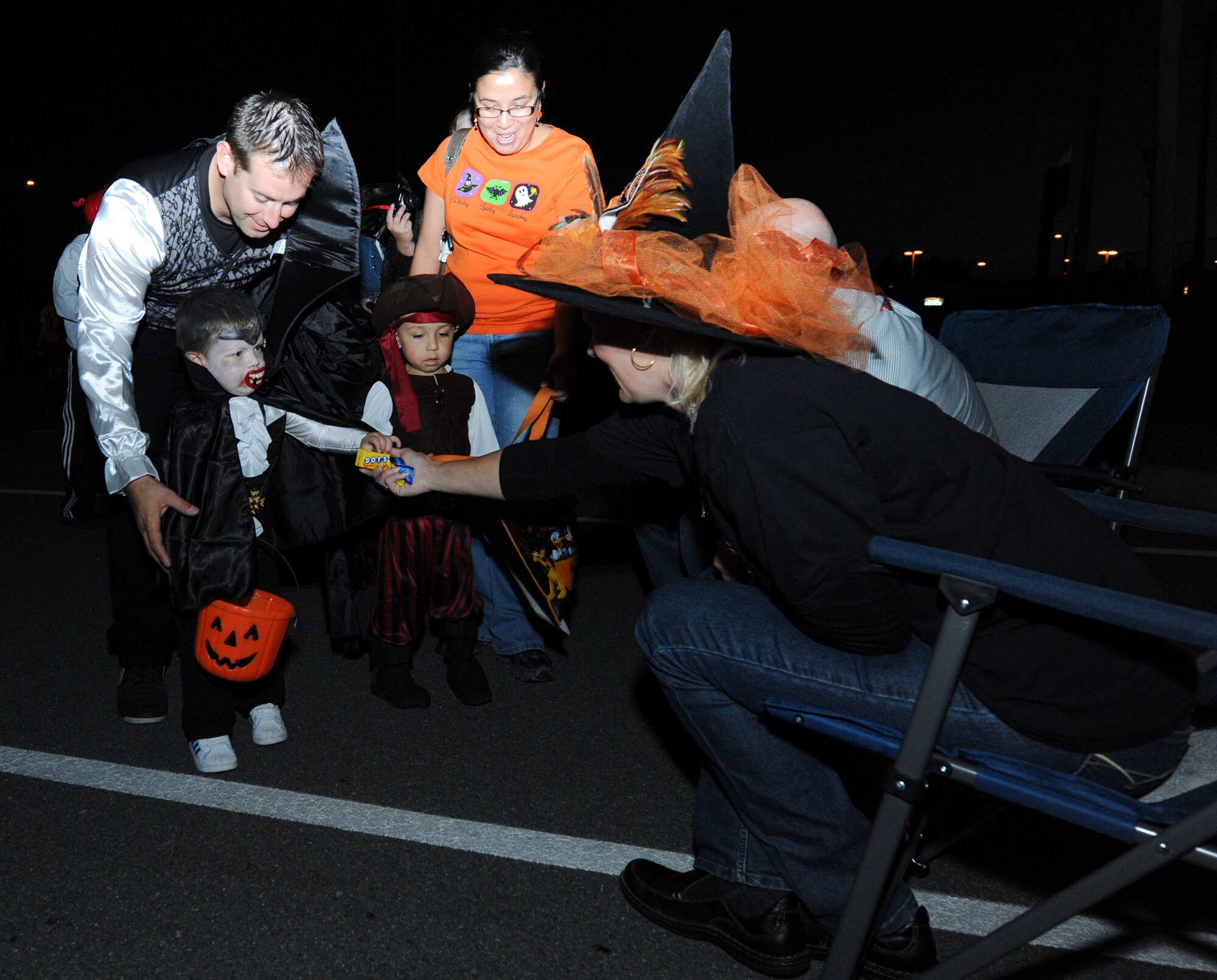 Andrea Sheddan, wife of Lt. Col. Jake Sheddan, 314th Airlift Wing chief of wing inspections, hands candy to kids during a trunk or treat event Oct. 20, 2012, at Little Rock Air Force Base, Ark. Sheddan was one of more than 50 volunteers that helped out with the event. (U.S. Air Force photo by Airman 1st Class Rusty Frank)