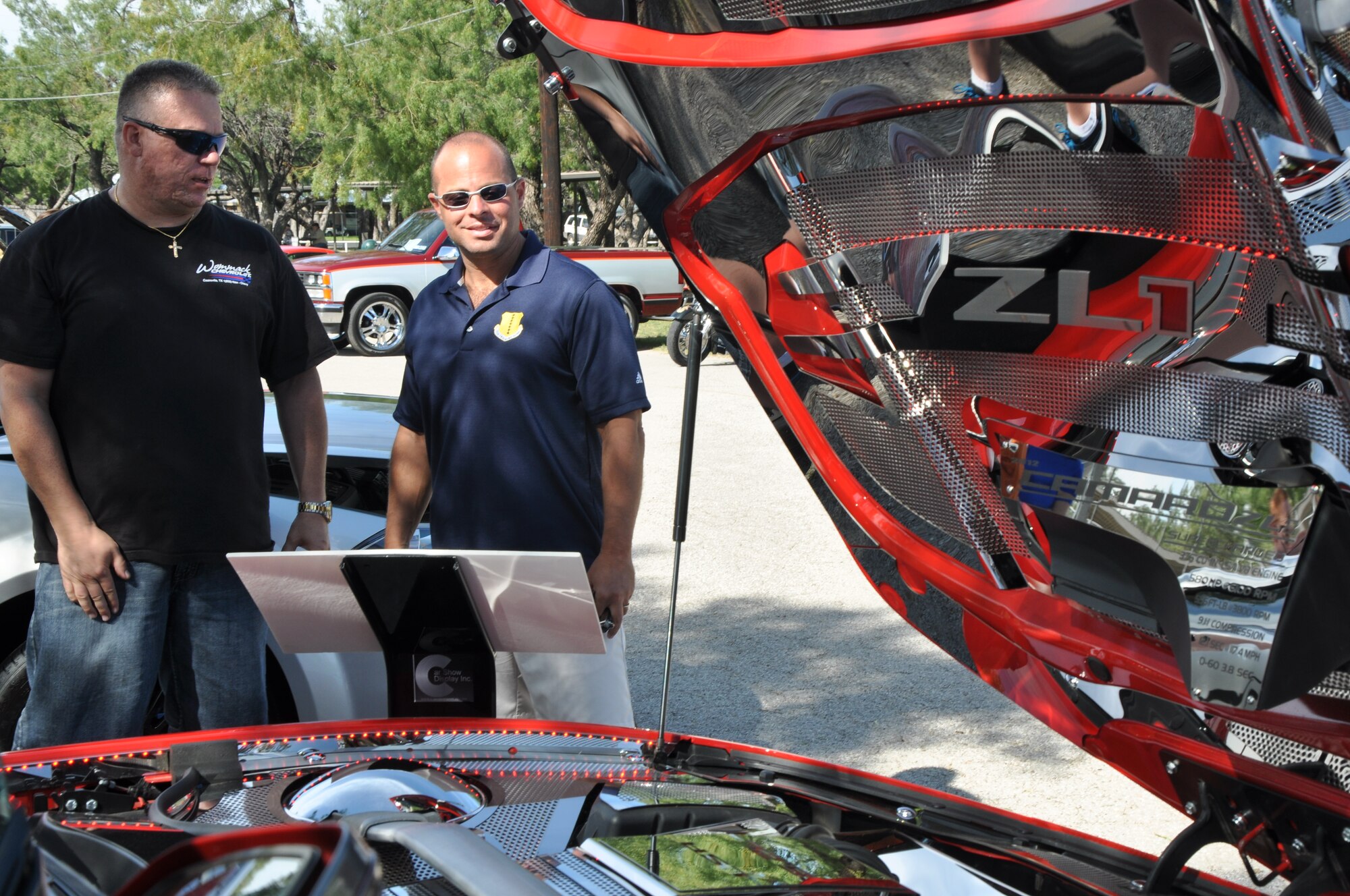 GOODFELLOW AIR FORCE BASE, Texas – (right) Col. Mark Damiano, 17th Training Wing commander, talks with Steve Staycoff, Goodfellow Air Force Base Rec Camp Car Show contestant, about his Chevrolet Camaro at the Goodfellow Rec Camp Oct. 20. This car was run in the modified category. (U.S. Air Force photo/ Airman 1st Class Joshua Edwards)