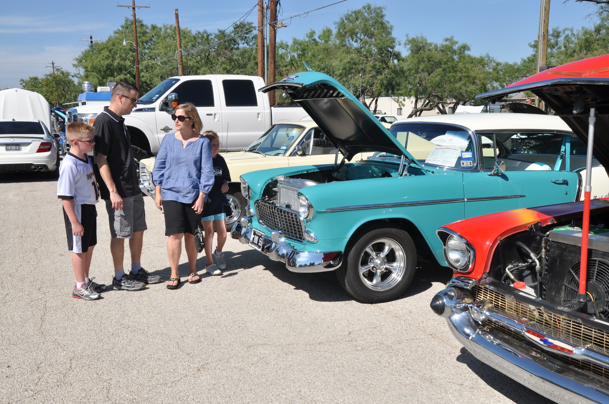 GOODFELLOW AIR FORCE BASE, Texas – Col. Thomas Schmidt, 17th Training Wing vice commander, and his family stop to look at one of the cars on display at the 14th Annual Goodfellow Air Force Base Rec Camp Car Show Oct. 20. This car was one of several cars the car show had from the 1950s. (U.S. Air Force photo/ Airman 1st Class Joshua Edwards)