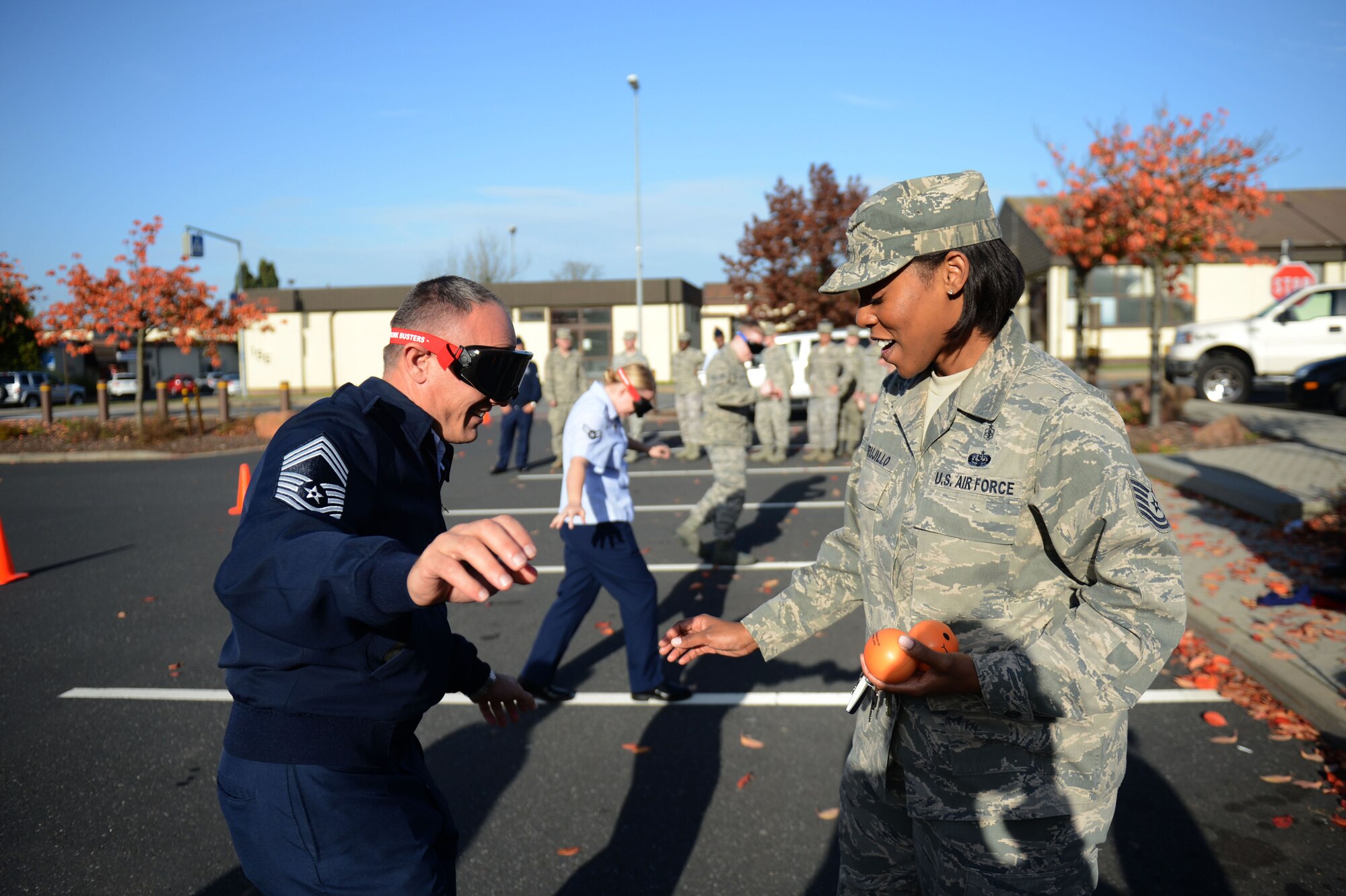 SPANGDAHLEM AIR BASE, Germany – U.S. Air Force Chief Master Sgt. Steven Foster, left, 52nd Medical Group superintendant from Boston and Tech. Sgt. Terri Trujillo, 52nd Medical Operations Squadron NCO in charge of the alcohol and drug abuse prevention and treatment program from Tampa Fla., participate in mock sobriety tests outside the Spangdahlem Skyline Movie Theater during a “Drunk Busters” obstacle course event Oct. 22, 2012.  The tests included throwing and catching exercises, walking in a straight line and picking up objects while wearing drunk-goggles simulating impairment. (U.S. Air Force photo by Airman 1st Class Gustavo Castillo/Released)