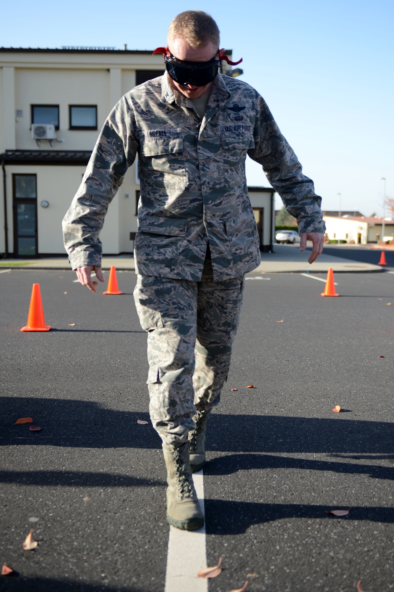 SPANGDAHLEM AIR BASE, Germany – U.S. Air Force Col. Joseph McFall, 52nd Fighter Wing vice commander from Maple Valley, Wash., walks on a line wearing drunk-goggles outside the Spangdahlem Skyline Movie Theater during a “Drunk Busters” obstacle course event Oct. 22, 2012.  The course went over the consequences of driving under the influence of alcohol, including loss of rank, a 60-day restriction to base, 45 days extra duty, loss of pay, 30 days confinement, a reprimand and driving privileges revoked for up to one year. (U.S. Air Force photo by Airman 1st Class Gustavo Castillo/Released)