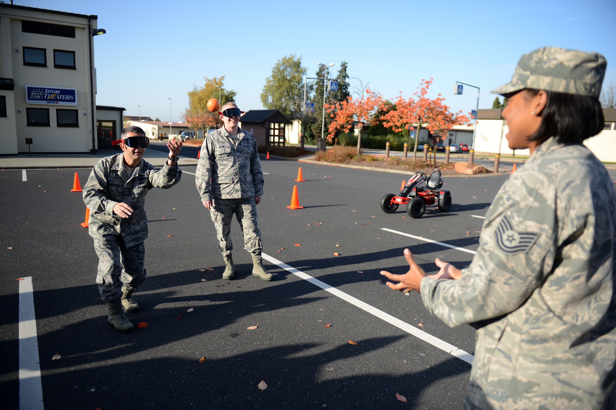 SPANGDAHLEM AIR BASE, Germany –U.S. Air Force Col. Dave Julazadeh, left, 52nd Fighter Wing commander from Peoria, Ill., and Col. Joseph McFall, 52nd Fighter Wing vice commander from Maple Valley, Wash., catch and throw foam balls while wearing drunk-goggles Oct. 22, 2012, outside of the Spangdahlem Skyline Movie Theater during a “Drunk Busters” obstacle course event.  The 52nd Medical Operations Squadron Alcohol and Drug Abuse Prevention and Treatment Program received 25 referrals for driving under the influence this year.  The purpose of this course is to aid in preventing alcohol-related incidents. (U.S. Air Force photo by Airman 1st Class Gustavo Castillo/Released)