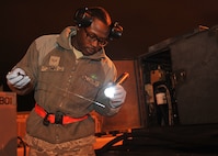 Senior Airman Shermar Jones, 22nd Maintenance Squadron aerospace ground equipment journeyman inspects the fluid level Oct. 23, 2012 McConnell Air Force Base, Kan. Aerospace ground equipment journeymen maintain and repair aircraft equipment to ensure that McConnell can carry out the mission. (U.S. Air Force photo/Airman 1st Class Maurice A. Hodges)