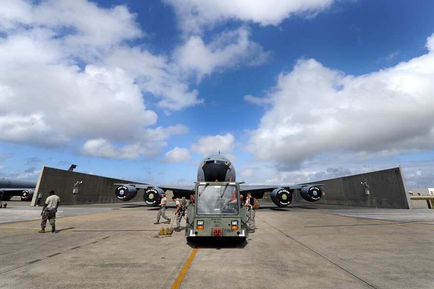 Airmen from the 718th Air Maintenance Squadron prepare to tow a U.S. Air Force KC-135 Stratotanker refueling aircraft to a new location during Exercise Beverly Bearcat, a Pacific Air Forces readiness inspection, on Kadena Air Base, Oct. 23, 2012. During the inspection, members of the PACAF’s Inspector General team tested the wing’s ability to support and sustain its mission during a contingency. (U.S. Air Force photo/Airman 1st Class Brooke P. Beers)