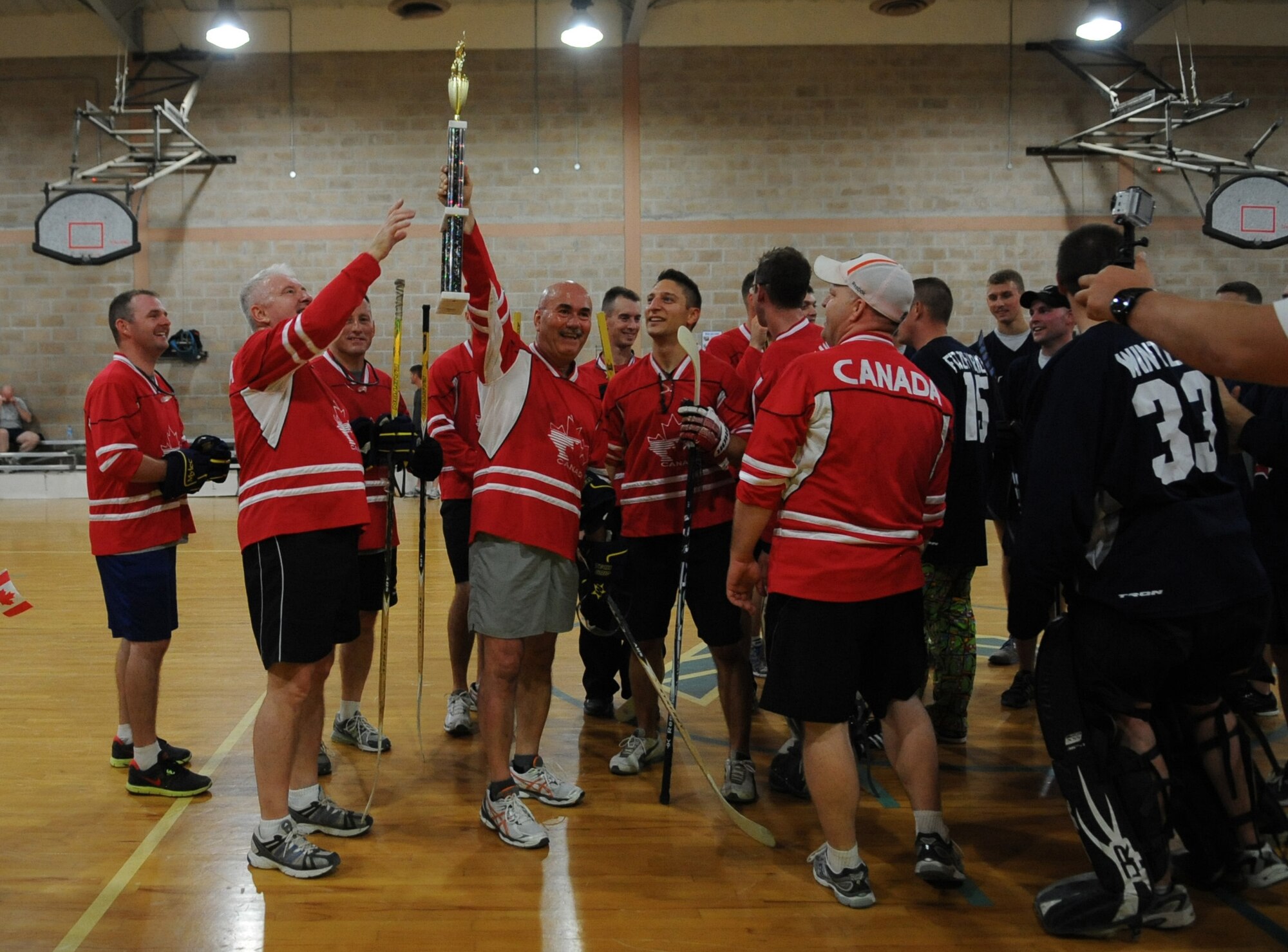 SOUTHWEST ASIA – Warrant Officer 1 Terri Wood, Canadian hockey player, holds the championship trophy after beating Team USA, 12-4. The event brought personnel together from two allied nations to “battle it out” floor hockey style for bragging rights.  (U.S. Air Force photo/Staff Sgt. Alexandra M. Boutte) 