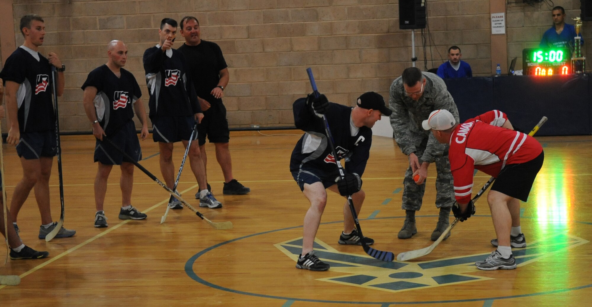 SOUTHWEST ASIA – Col. David Farrow, 386th Air Expeditionary Wing commander drops the hockey puck in the start of the first period of the game between Team USA and Team Canada here Oct. 12.   (U.S. Air Force photo/Staff Sgt. Alexandra M. Boutte) 