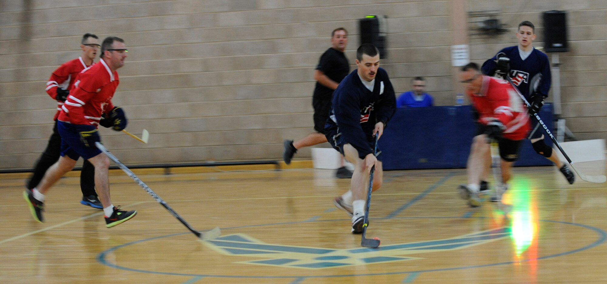 SOUTHWEST ASIA – Senior Airman Dylan Gillis, 727th Expeditionary Air Control Squadron, heating, ventilation and air conditioning technician and the 386th Air Expeditionary Wing’s hockey league commissioner, weave in-and-out of the Canadians during a hockey game here Oct. 12. Gillis has been playing hockey since his parents gave him his first hockey stick at the age of 3. (U.S. Air Force photo/Staff Sgt. Alexandra M. Boutte) 