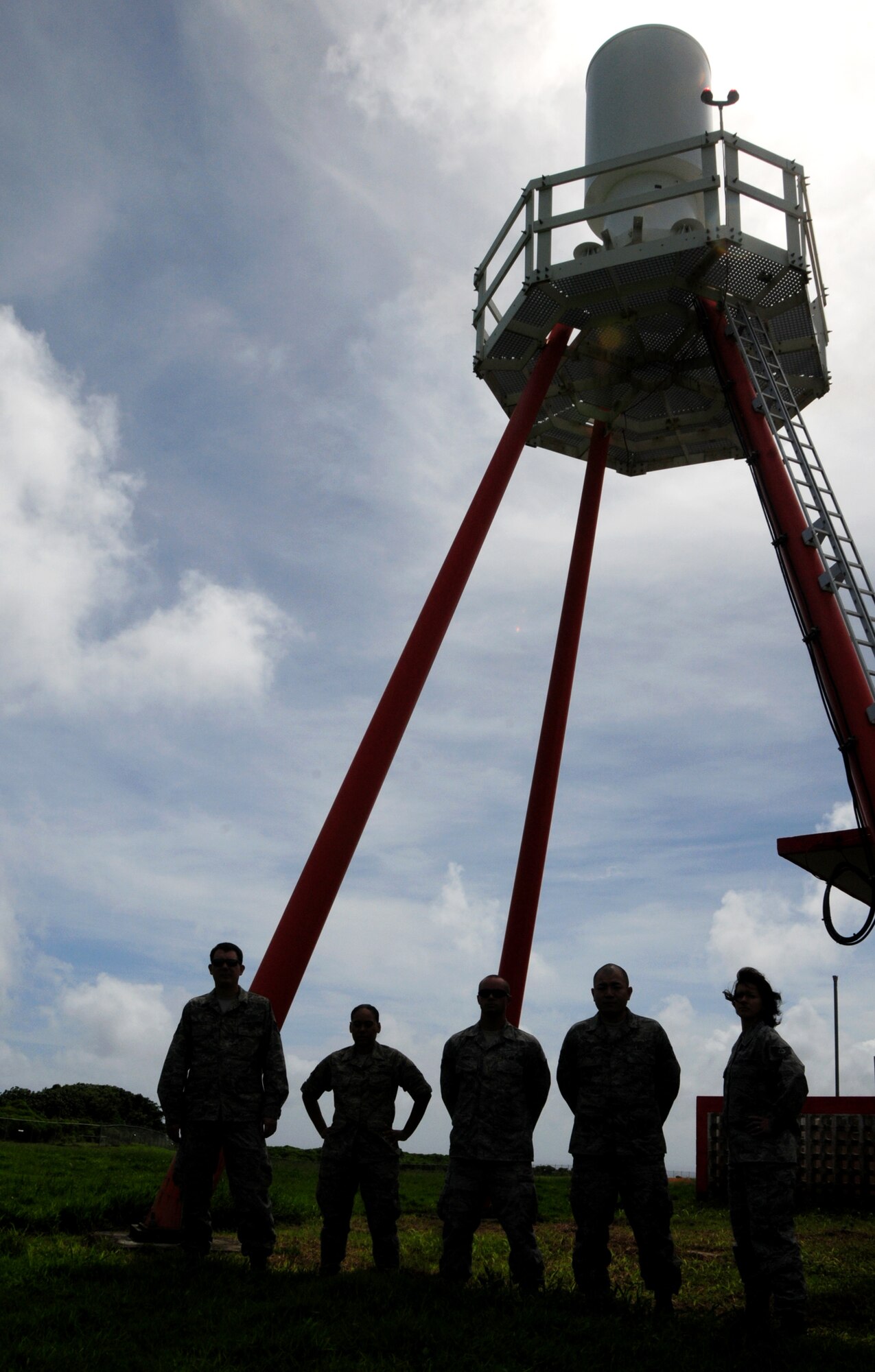 ANDERSEN AIR FORCE BASE, Guam – Airmen from the 36th Communications Squadron’s airfield systems stand underneath a Tactical Air Navigation system on the flightline here, Oct 18. The TACAN is used by military aircraft and provides the aircrew with slant-range distance and bearing information to a ground station. (U.S. Air Force photo by Airman 1st Class Marianique Santos/Released)