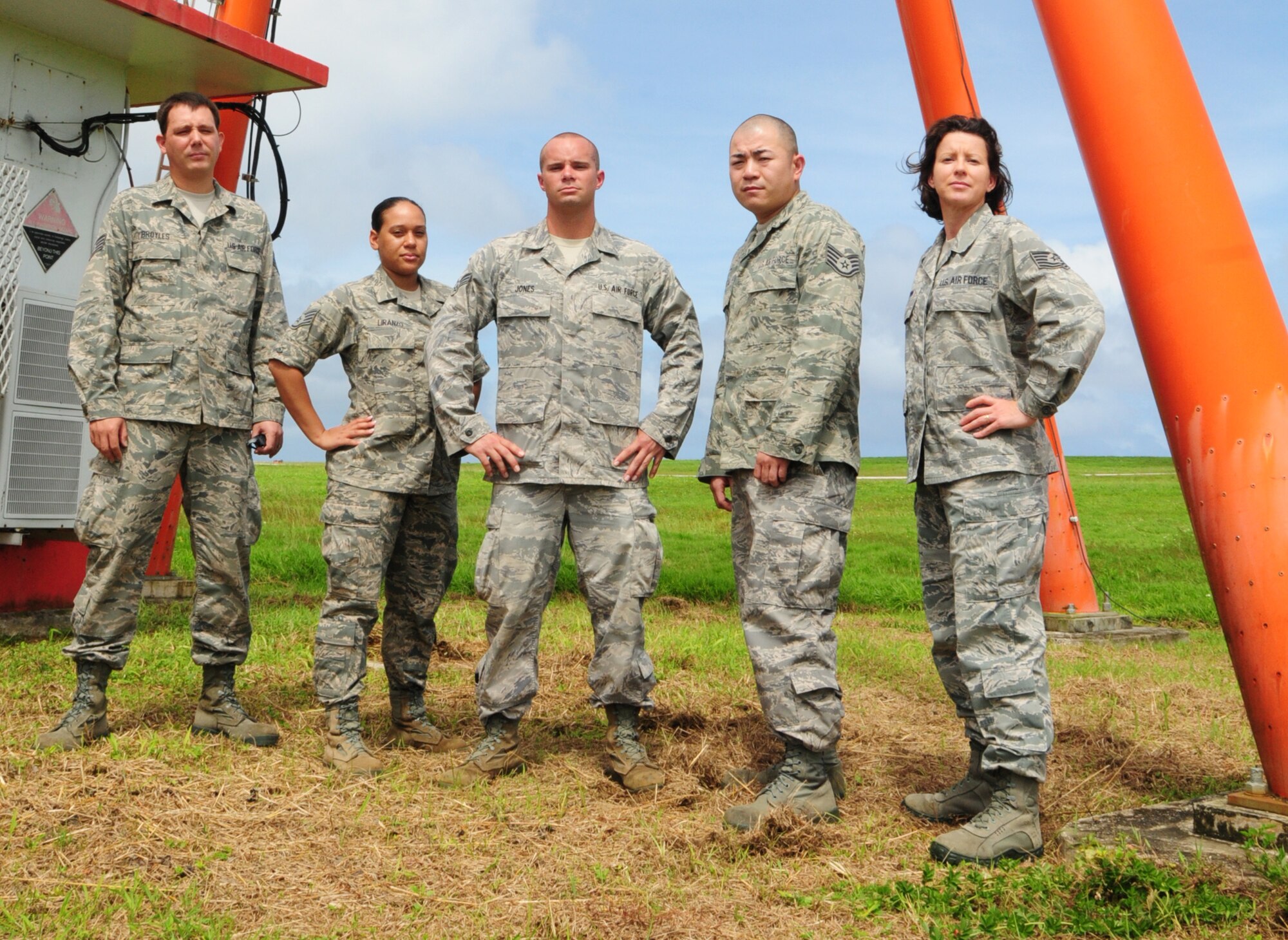 ANDERSEN AIR FORCE BASE, Guam – Airmen from the 36th Communications Squadron’s airfield systems stand underneath a Tactical Air Navigation system on the flightline here, Oct. 18. The Airfield systems section is responsible for supporting the 36th Wing in continuous air traffic control, instrumental landing and navigation and local weather data collection capabilities for aircraft missions and runway approaches. (U.S. Air Force photo by Airman 1st Class Marianique Santos/Released)