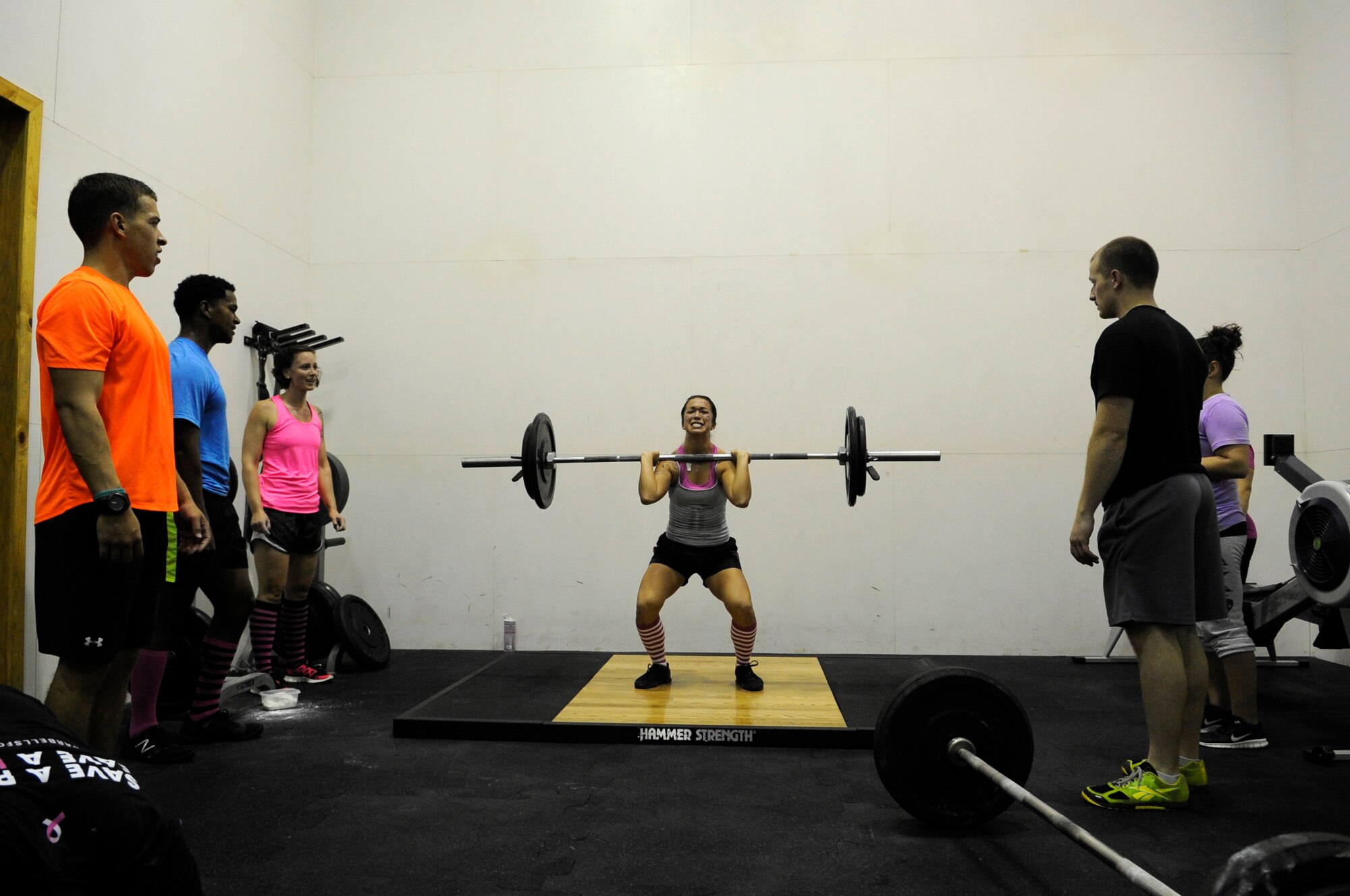 Senior Airman Angela Hicks, 8th Medical Support Squadron, performs a clean and jerk during a CrossFit workout Oct. 20, 2012, at Kunsan Air Base. The workout was held in support of Breast Cancer Awareness Month, which aims to save lives through early detection. (U.S. Air Force photo/Senior Airman Brigitte N. Brantley)
